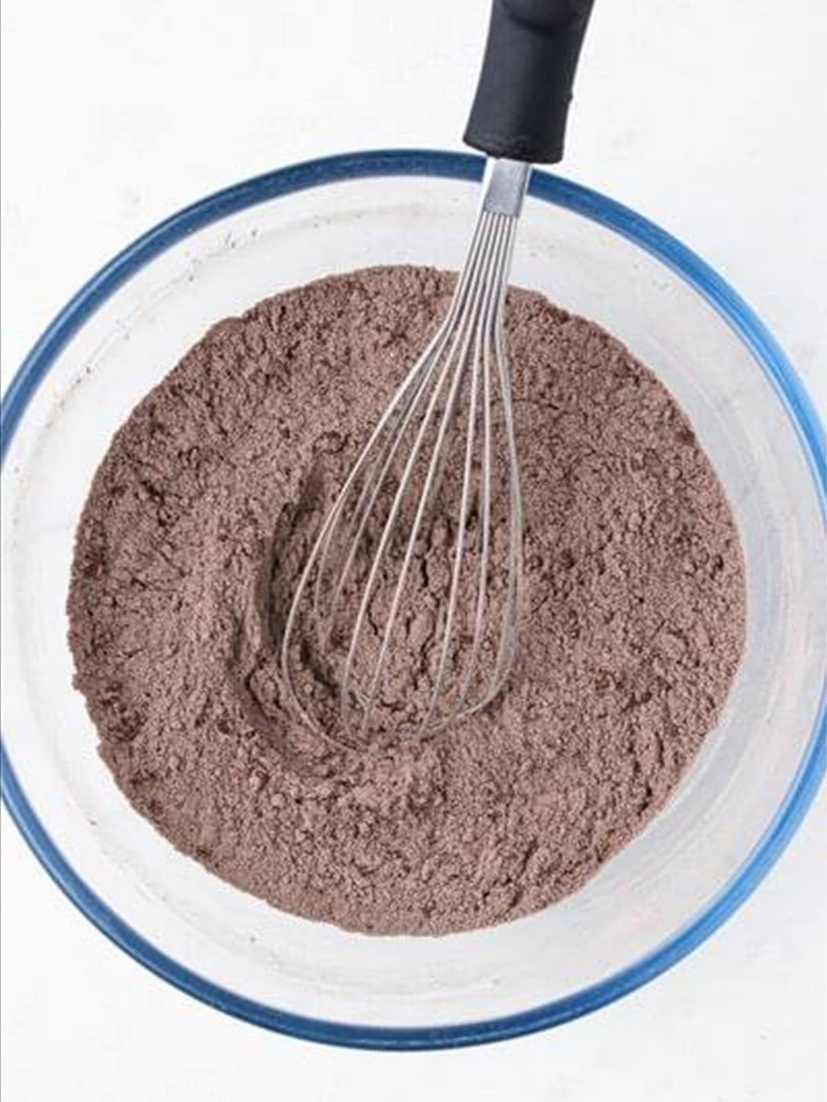 Whisking dry ingredients for chocolate caramel cake.