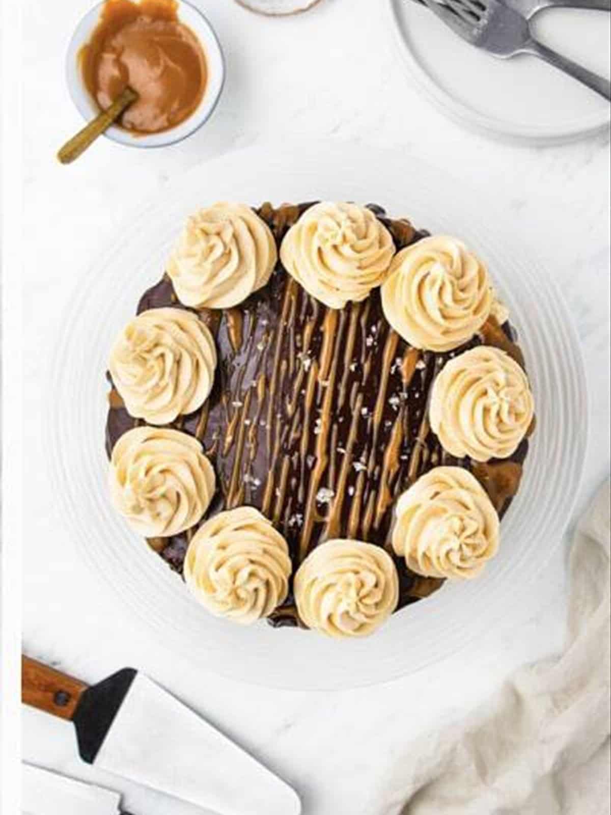Piping rosettes to decorate the chocolate caramel cake.