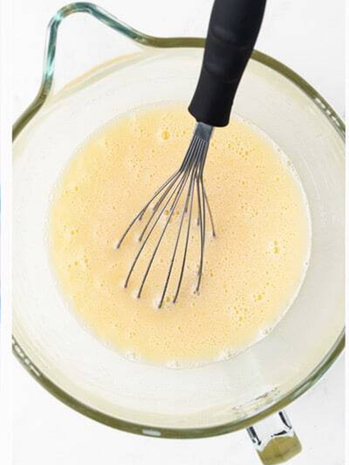 Whisking wet ingredients for chocolate caramel cake.