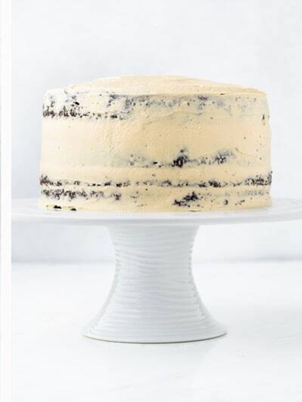 Crumb coating the stacked chocolate caramel cake.