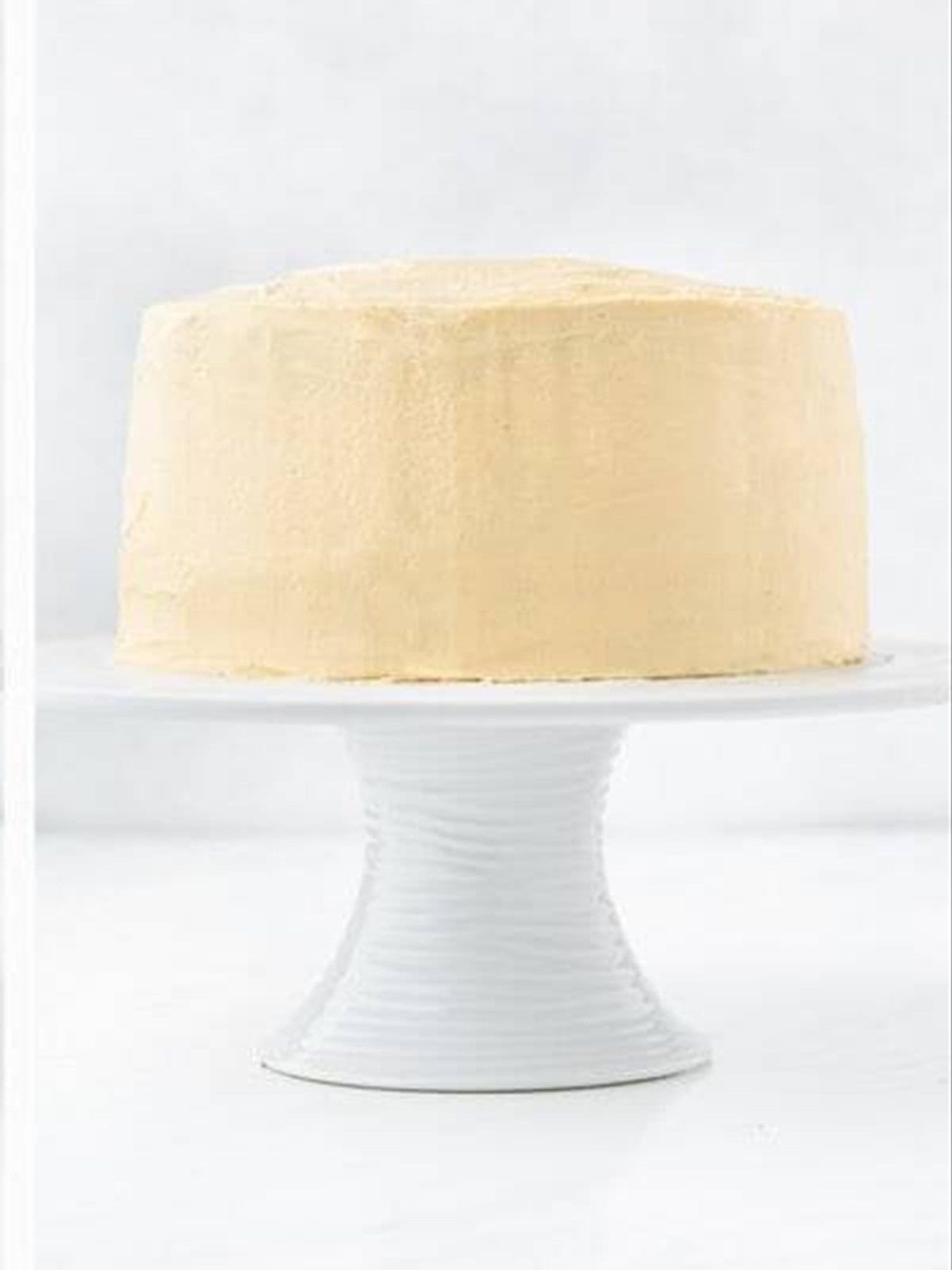 Applying the final coat of caramel frosting to chocolate caramel cake.