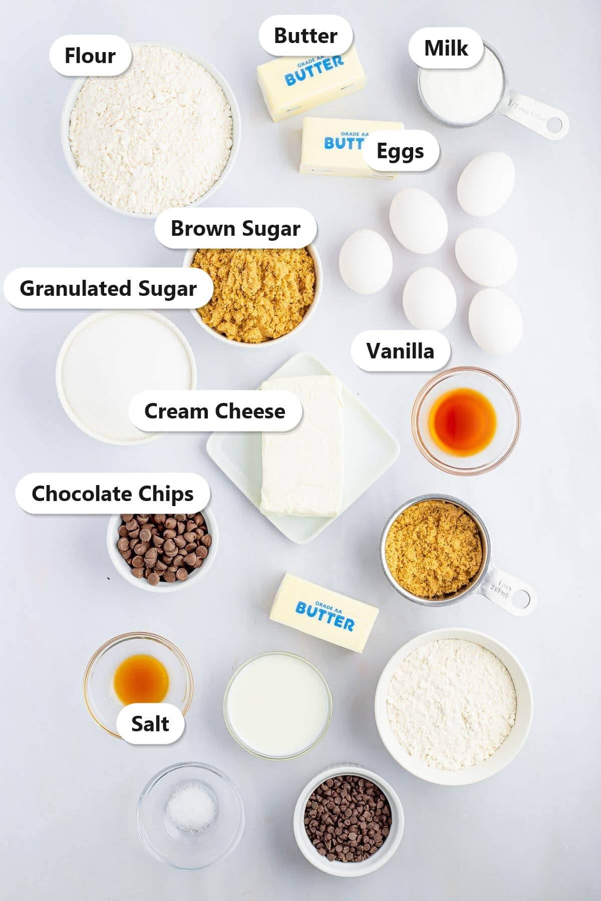 Labeled ingredients for chocolate chip bundt cake including flour, butter, cream cheese, eggs, brown sugar, and chocolate chips.