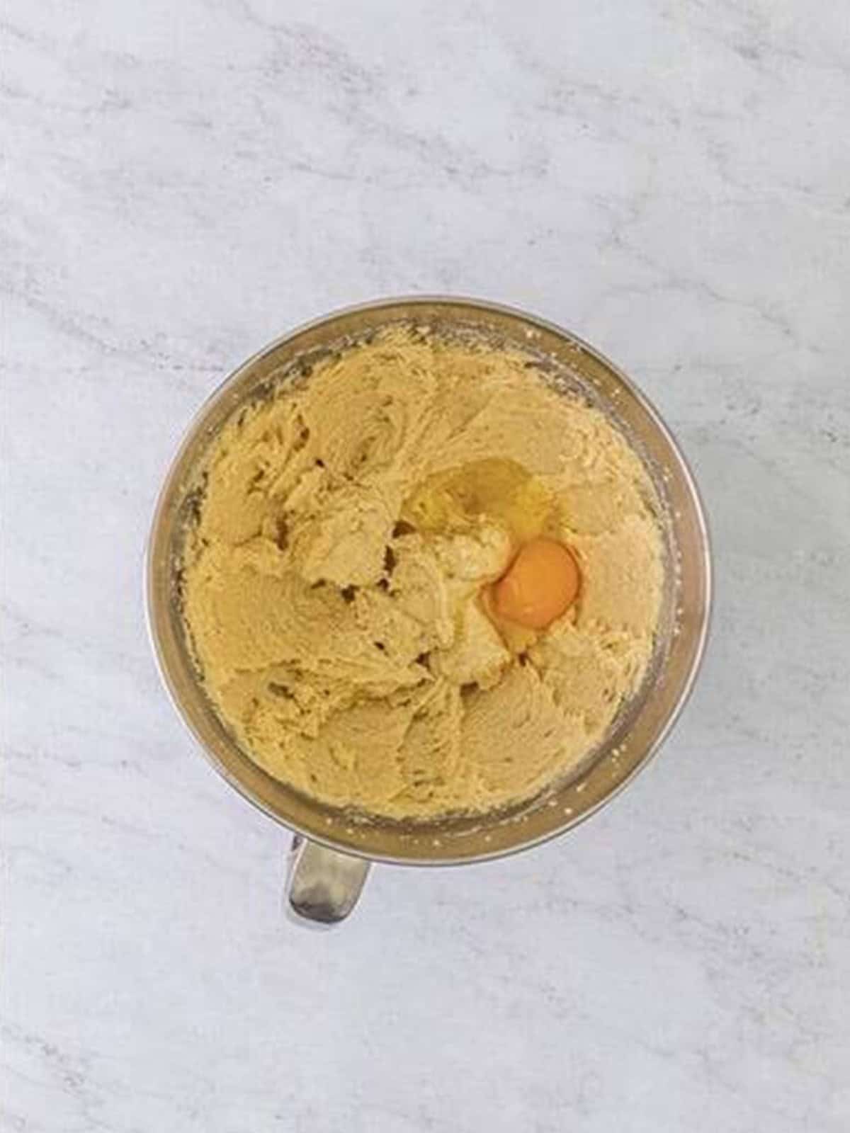 Chocolate chip cake batter creamed in a stand mixer with eggs.