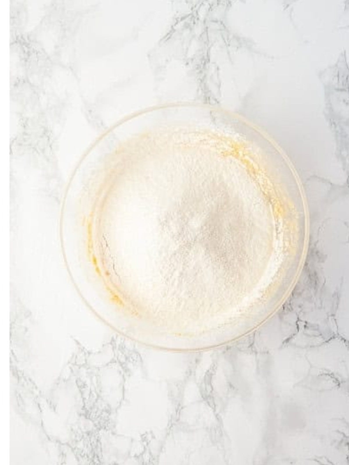Sifted flour and baking powder for Chocolate Chip Cookie Bars.