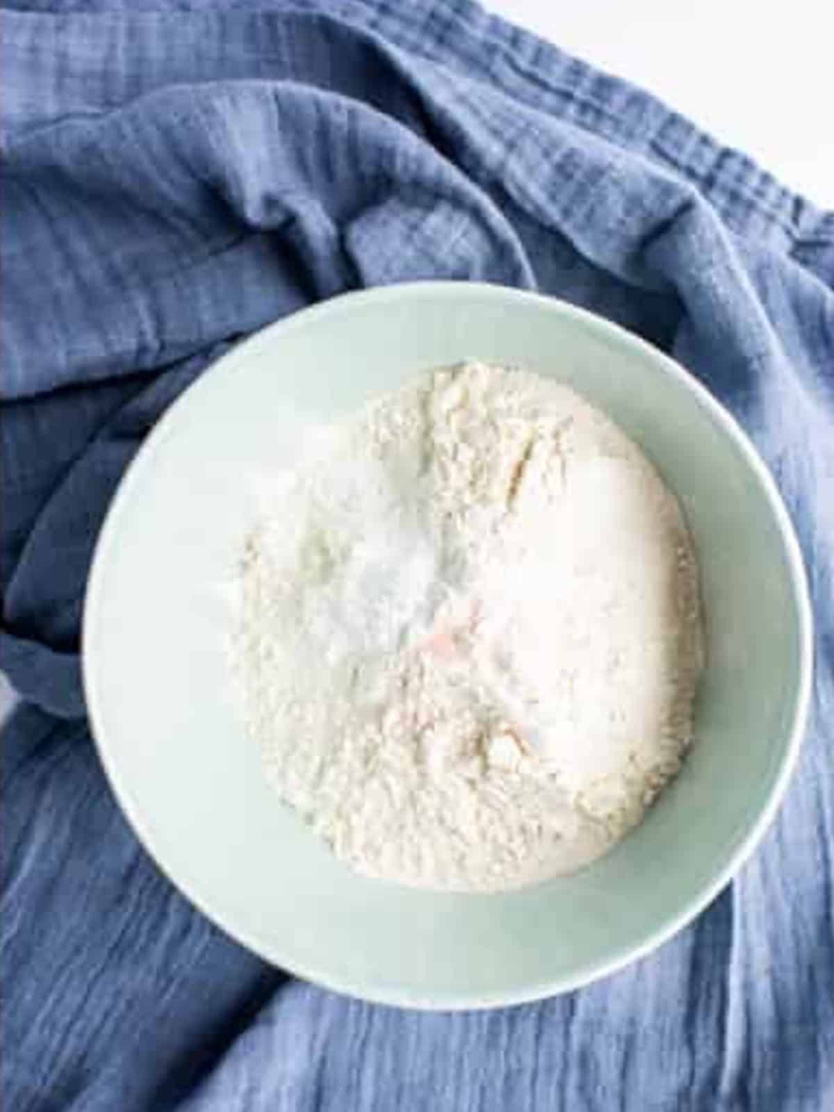 Flour, salt, and baking powder mixed in a bowl for Chocolate Chip Cookie Sandwiches.