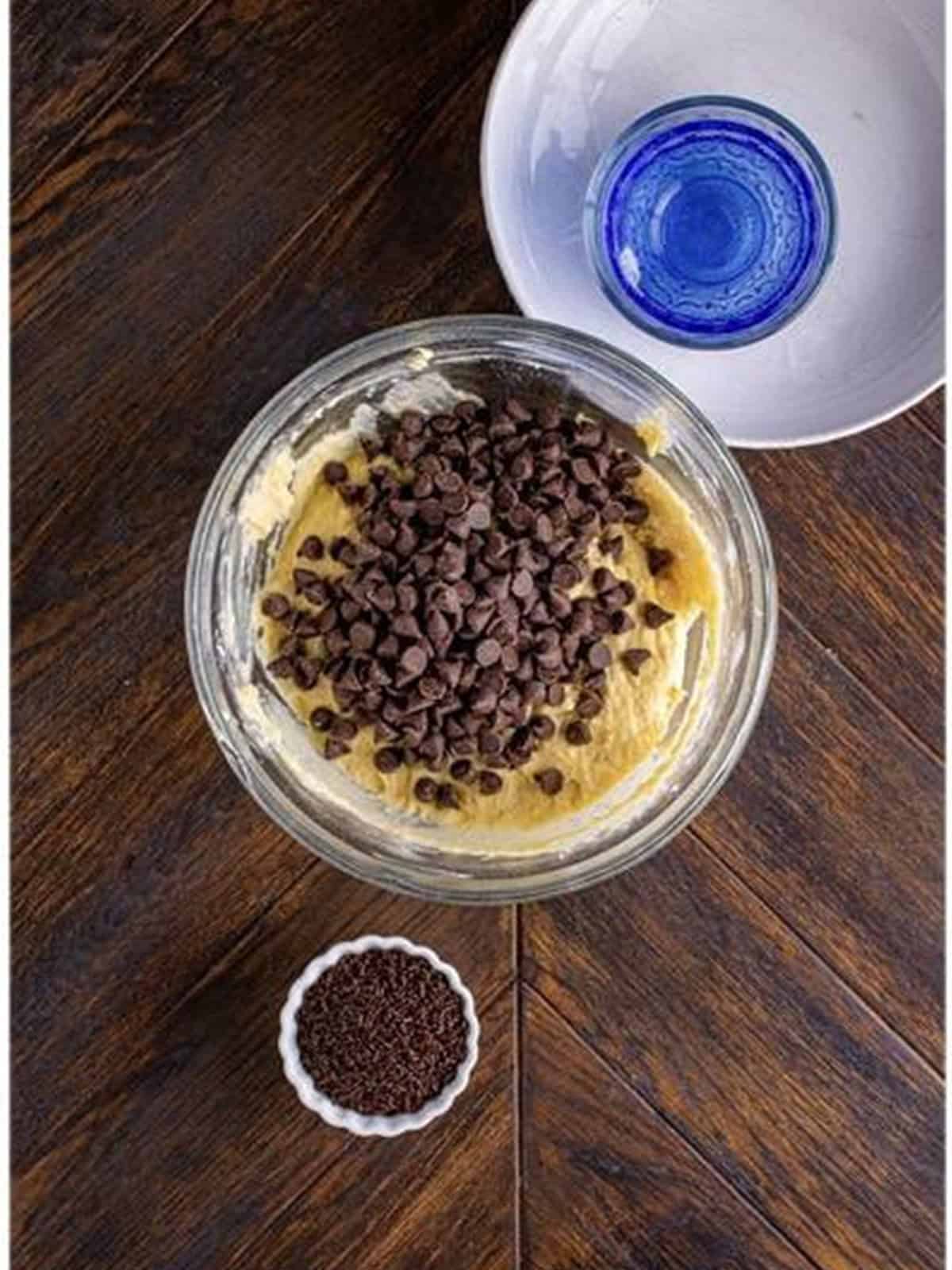 Folding chocolate chips into the smooth donut batter.