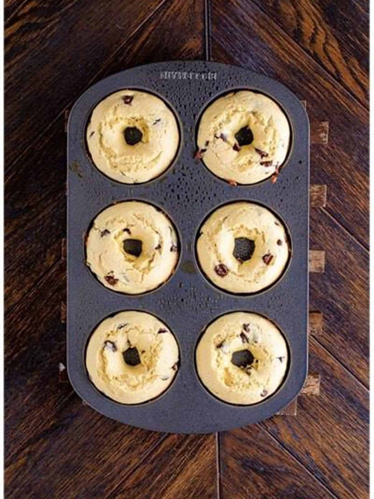 Baked chocolate chip donuts in a donut pan fresh from the oven.