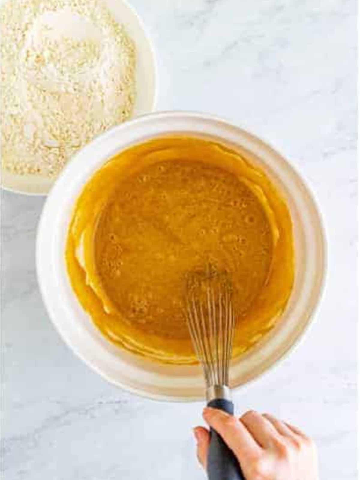 Whisking brown sugar, butter, eggs, and vanilla into a smooth batter.