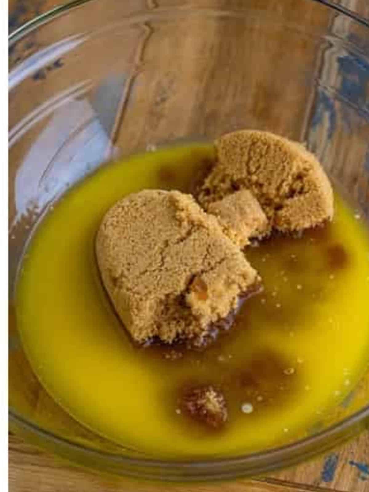 Melted butter and brown sugar in a mixing bowl for chocolate cookie bars.