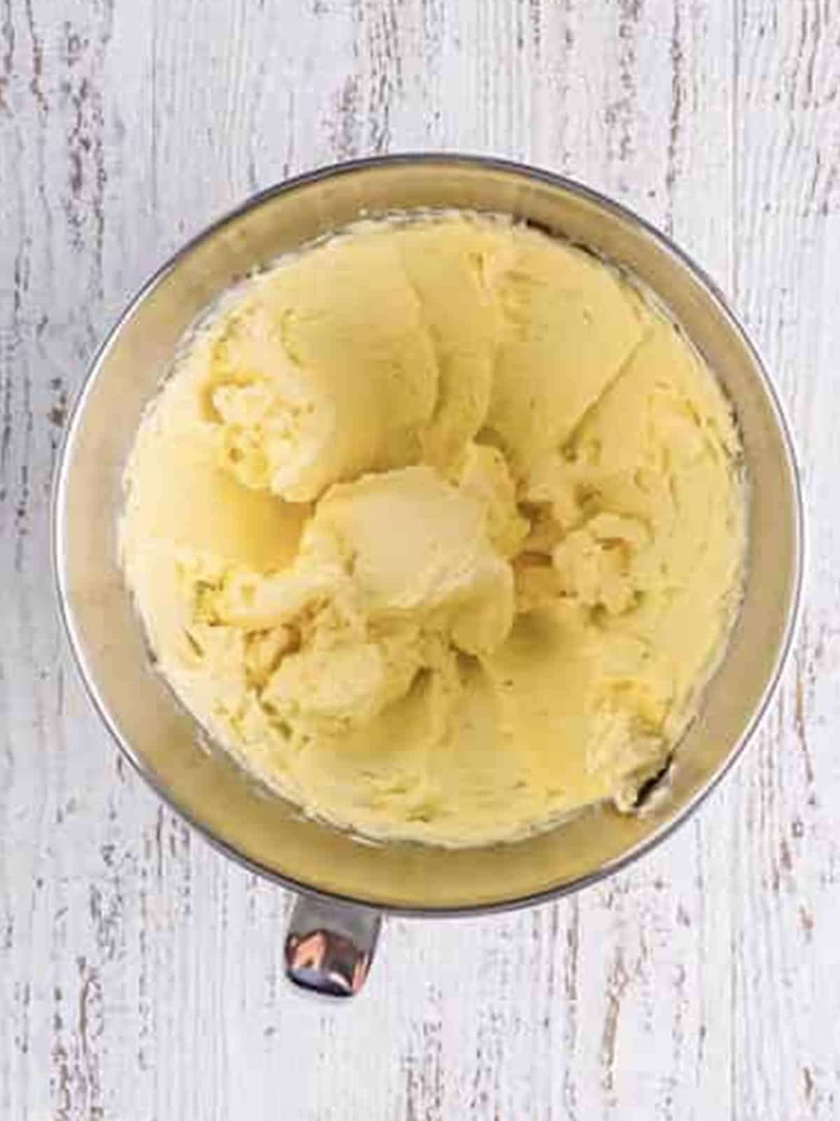 Cream cheese and butter creamed until smooth in a stand mixer bowl.