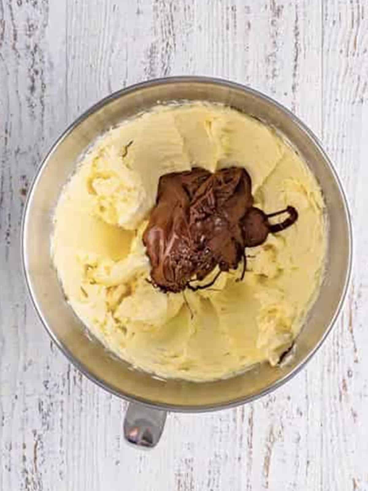 Melted chocolate added to the creamed butter and cream cheese.
