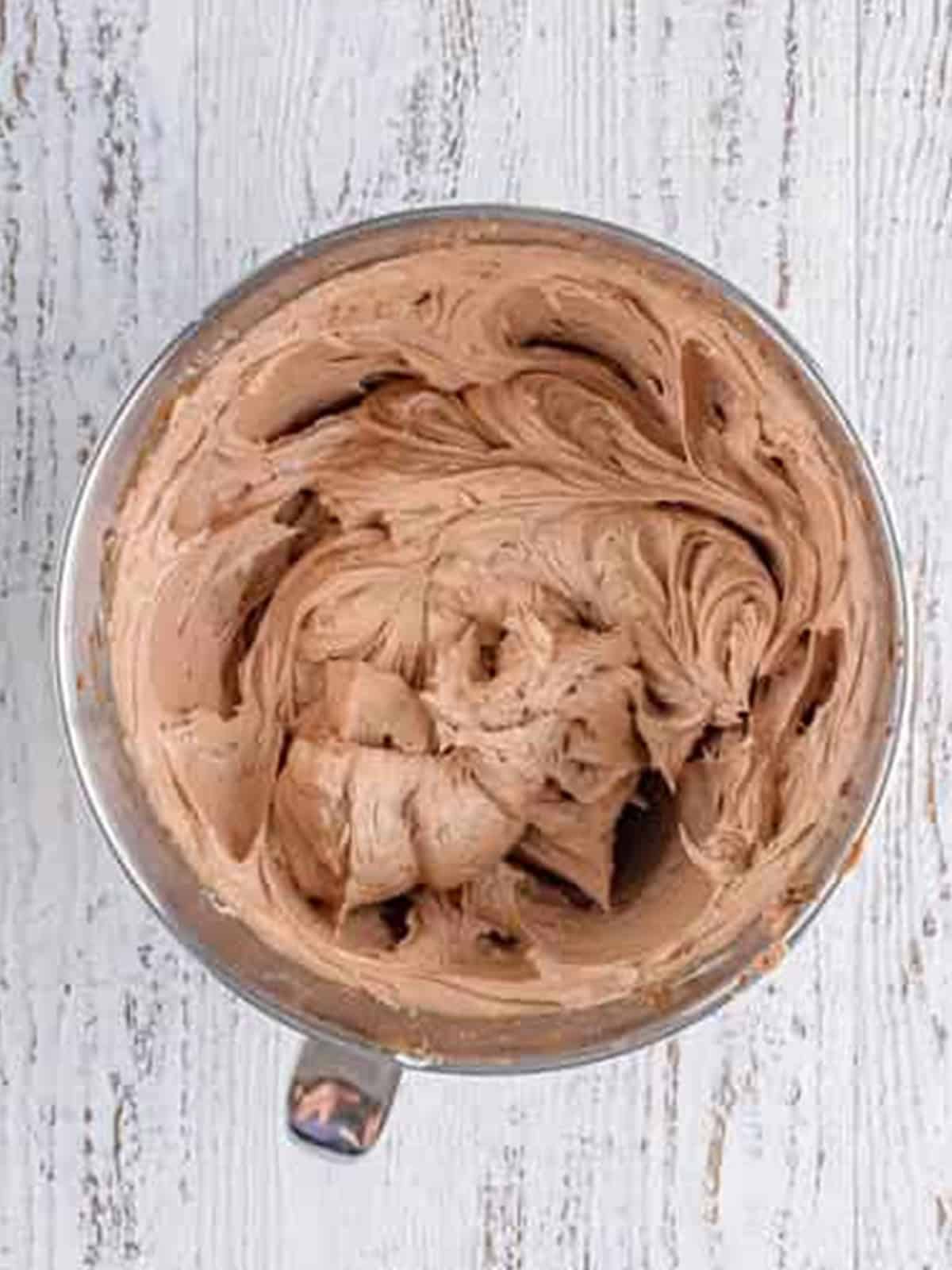 Whipped chocolate cream cheese frosting, light and fluffy in the mixer bowl.