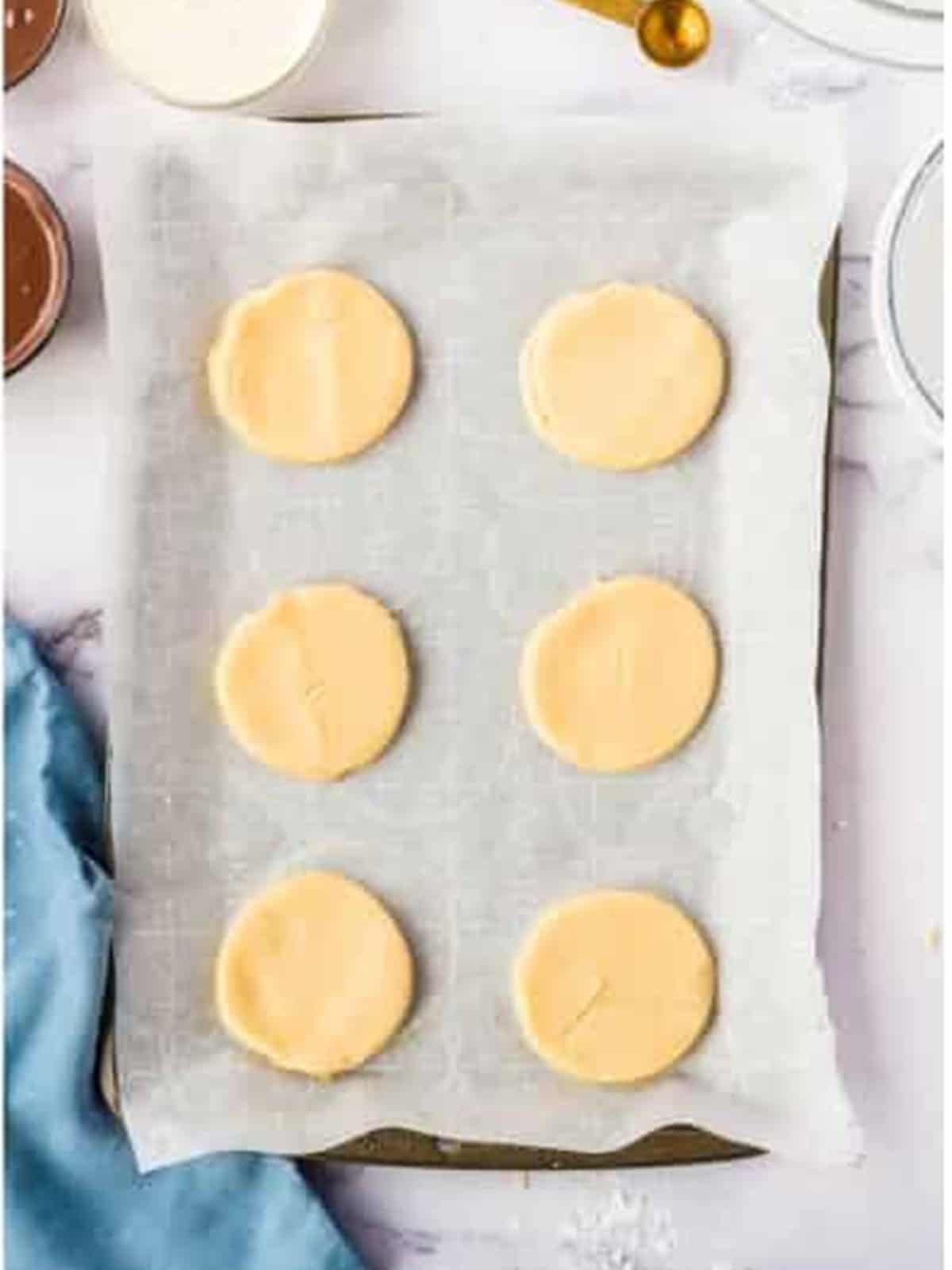 Cut shortbread cookie rounds on parchment paper