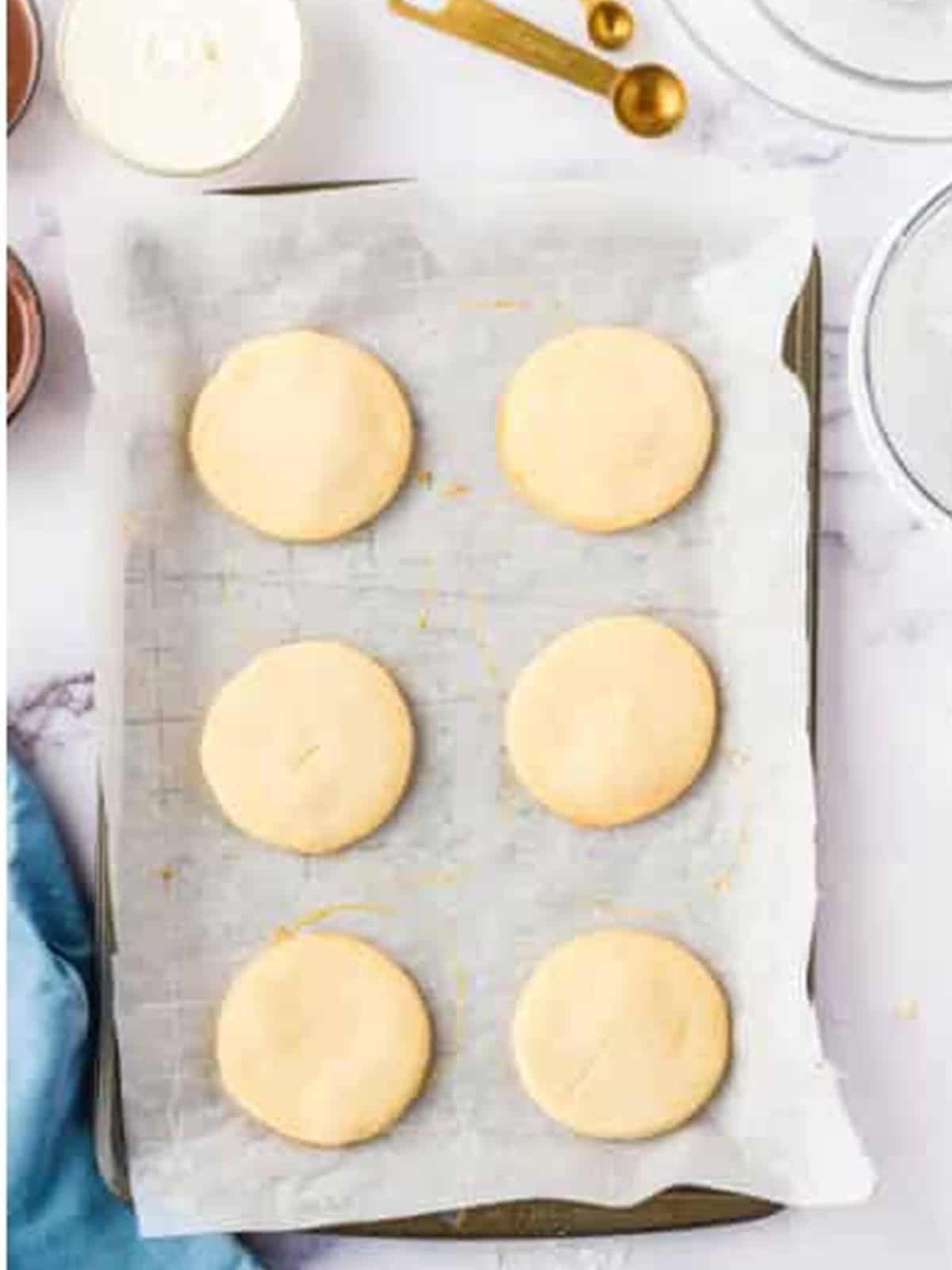 Baked shortbread cookies cooling on parchment