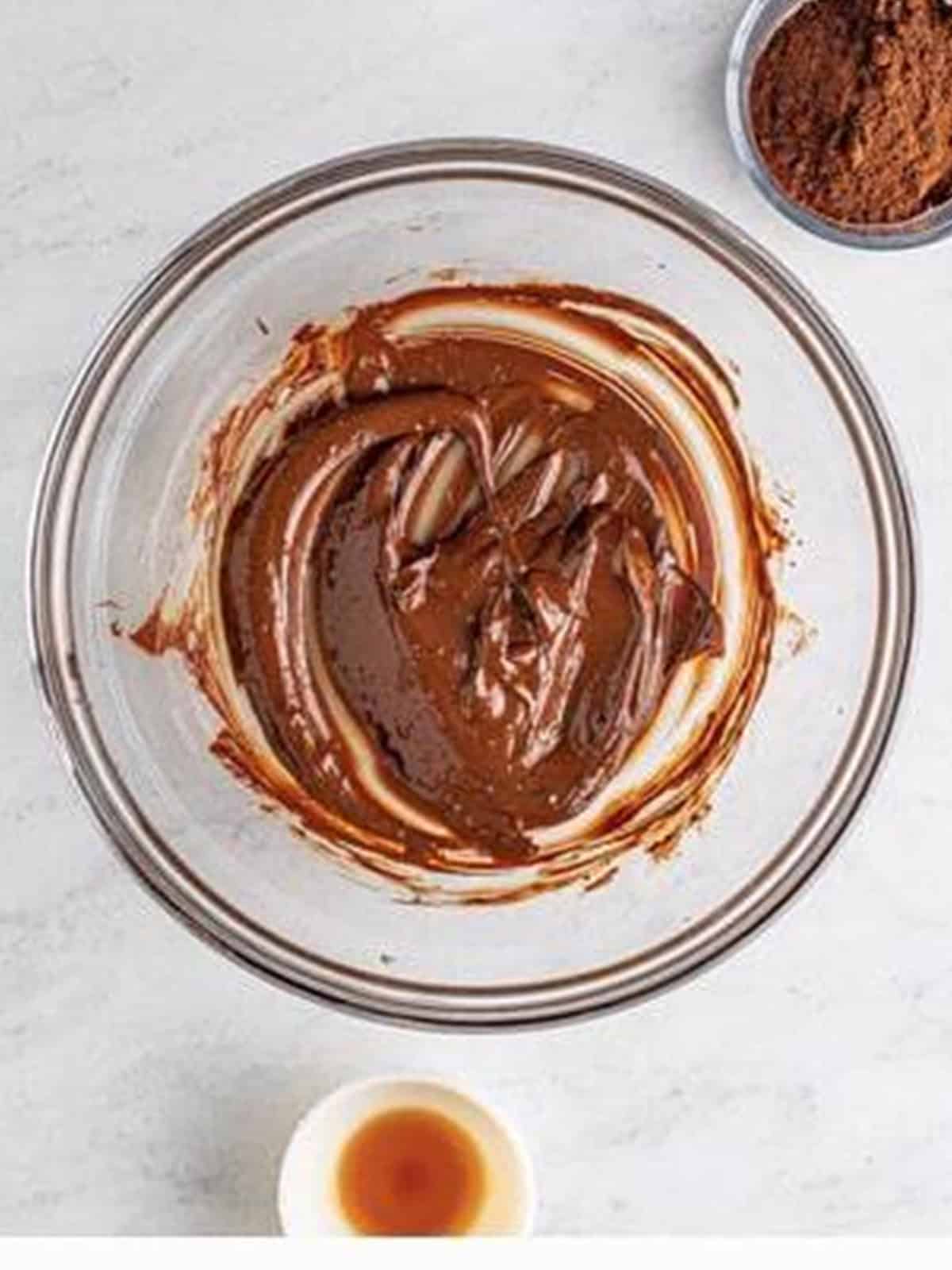 Melted semi-sweet chocolate and butter in a glass bowl for chocolate mousse.