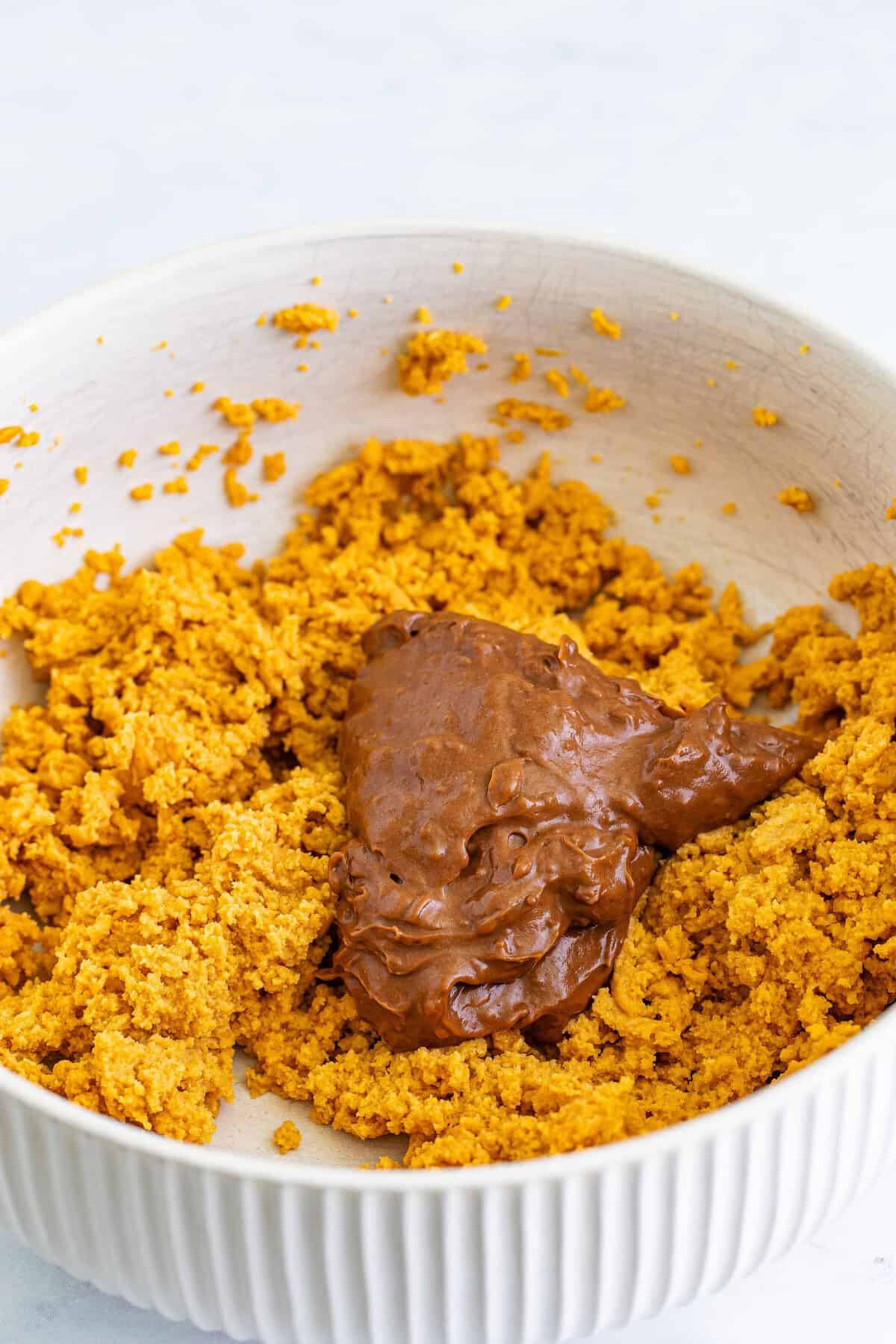 Adding chocolate pudding to the peanut butter cream cheese mixture.