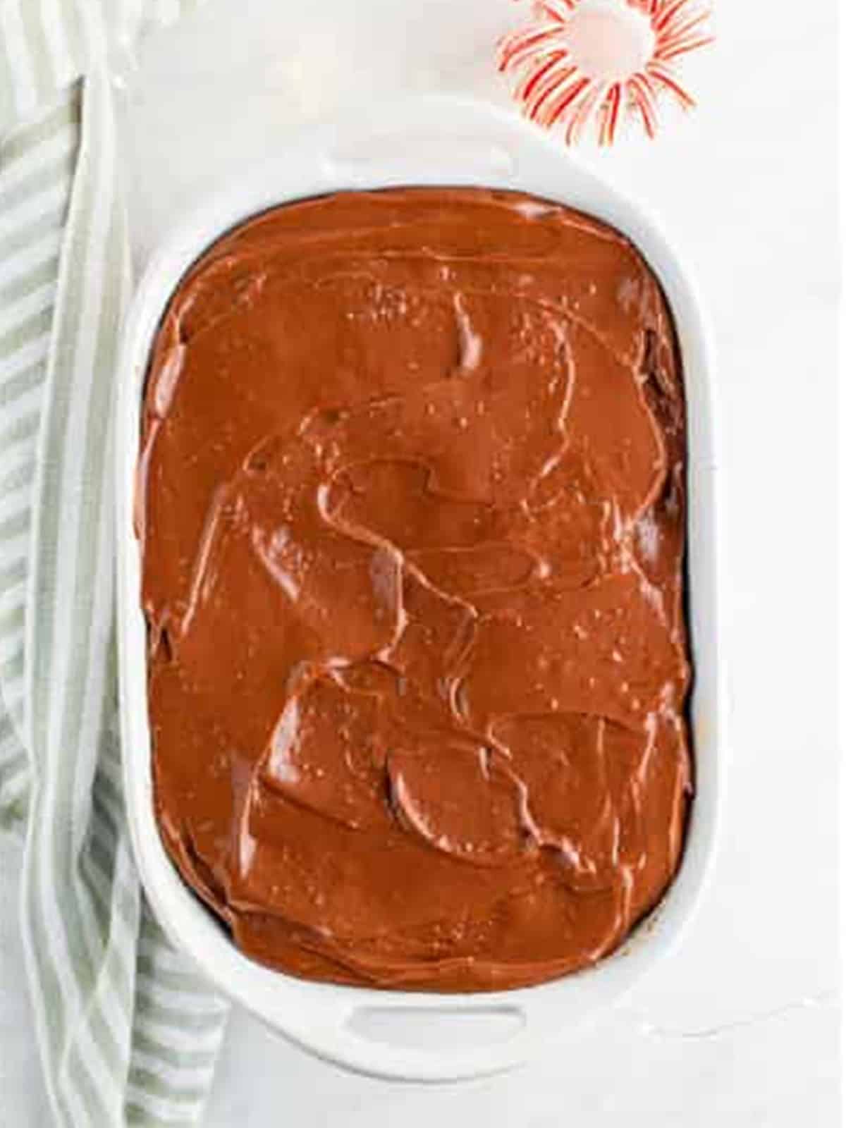 Chocolate peppermint pudding poured over the poked cake.