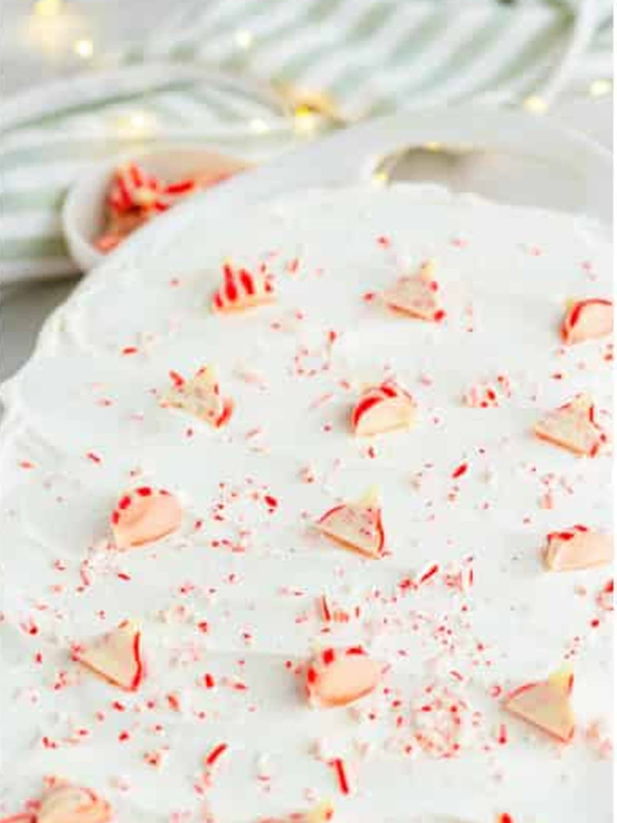 Finished chocolate peppermint poke cake garnished with candy cane kisses.