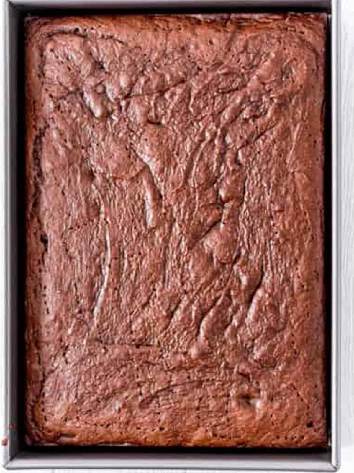 Baked chocolate cake in a metal baking pan.