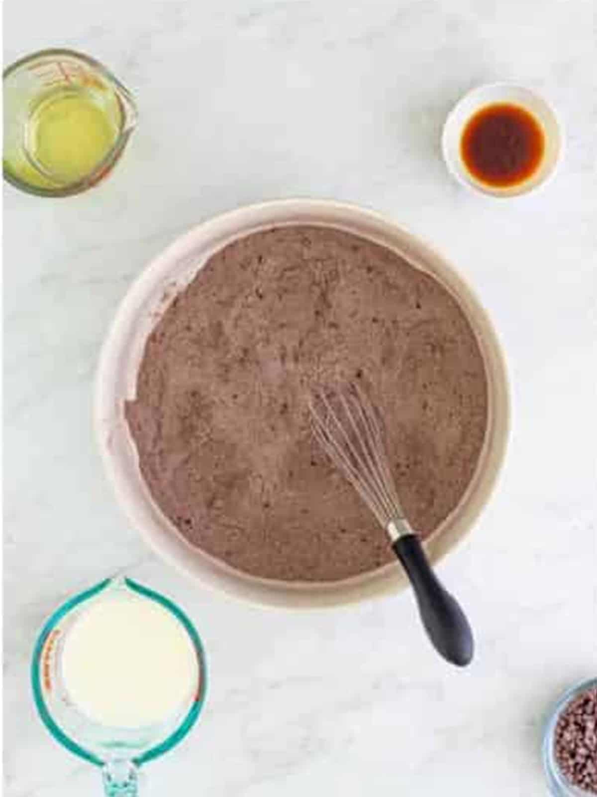 Dry ingredients whisked together in a bowl for chocolate pudding cake.
