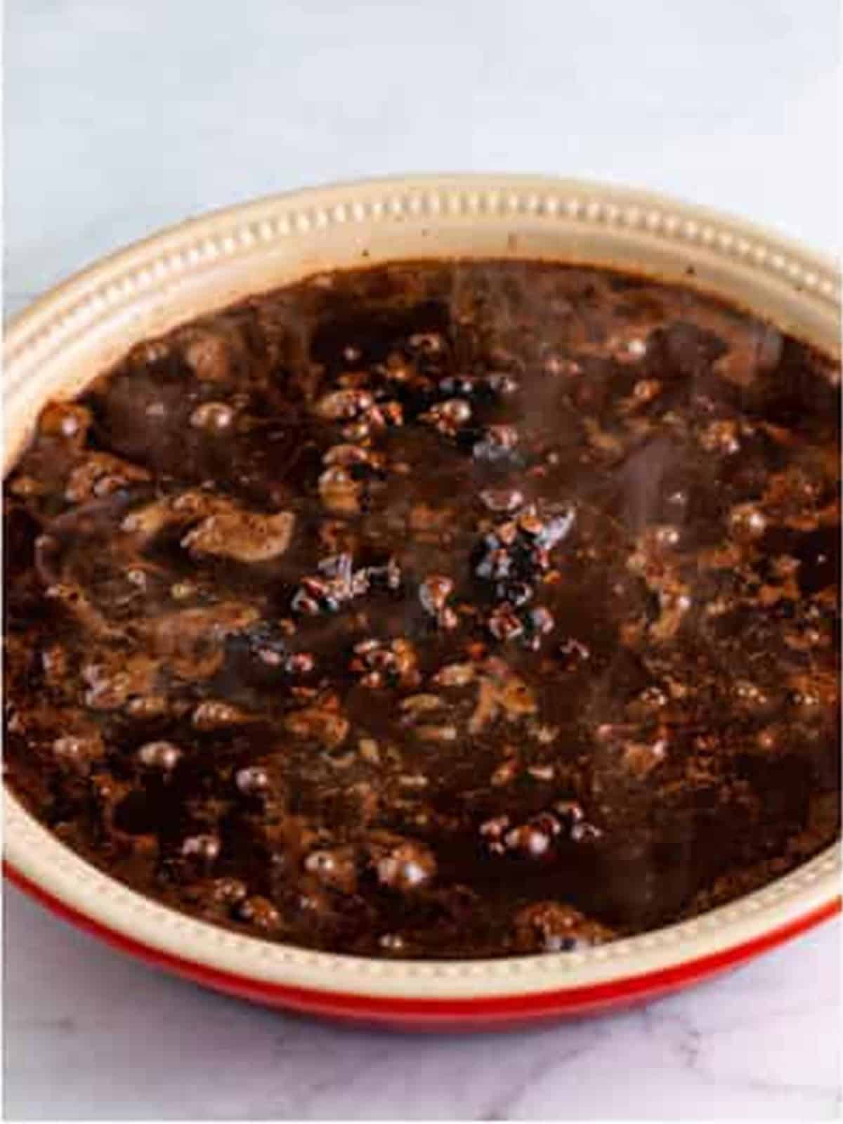 Boiling water poured over the sauce-topped batter before baking.