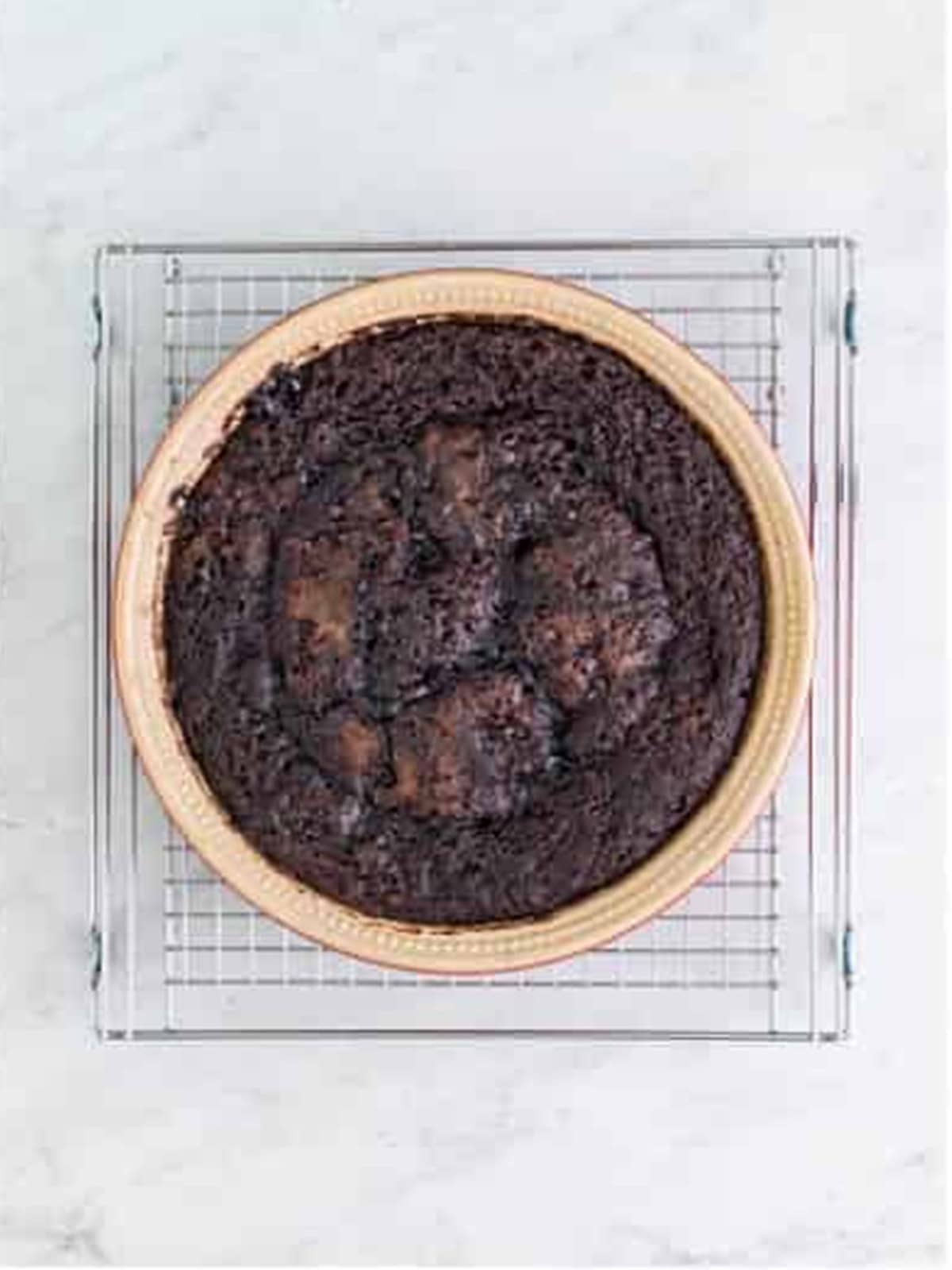 Baked chocolate pudding cake cooling in the dish.