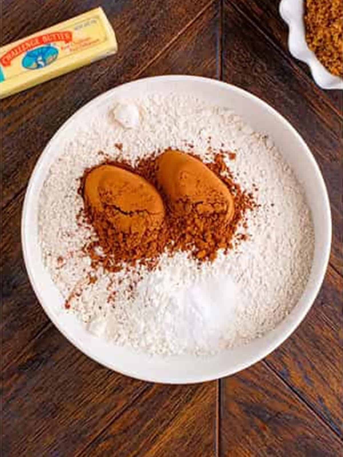Cocoa powder and flour whisked together for chocolate sugar cookies.