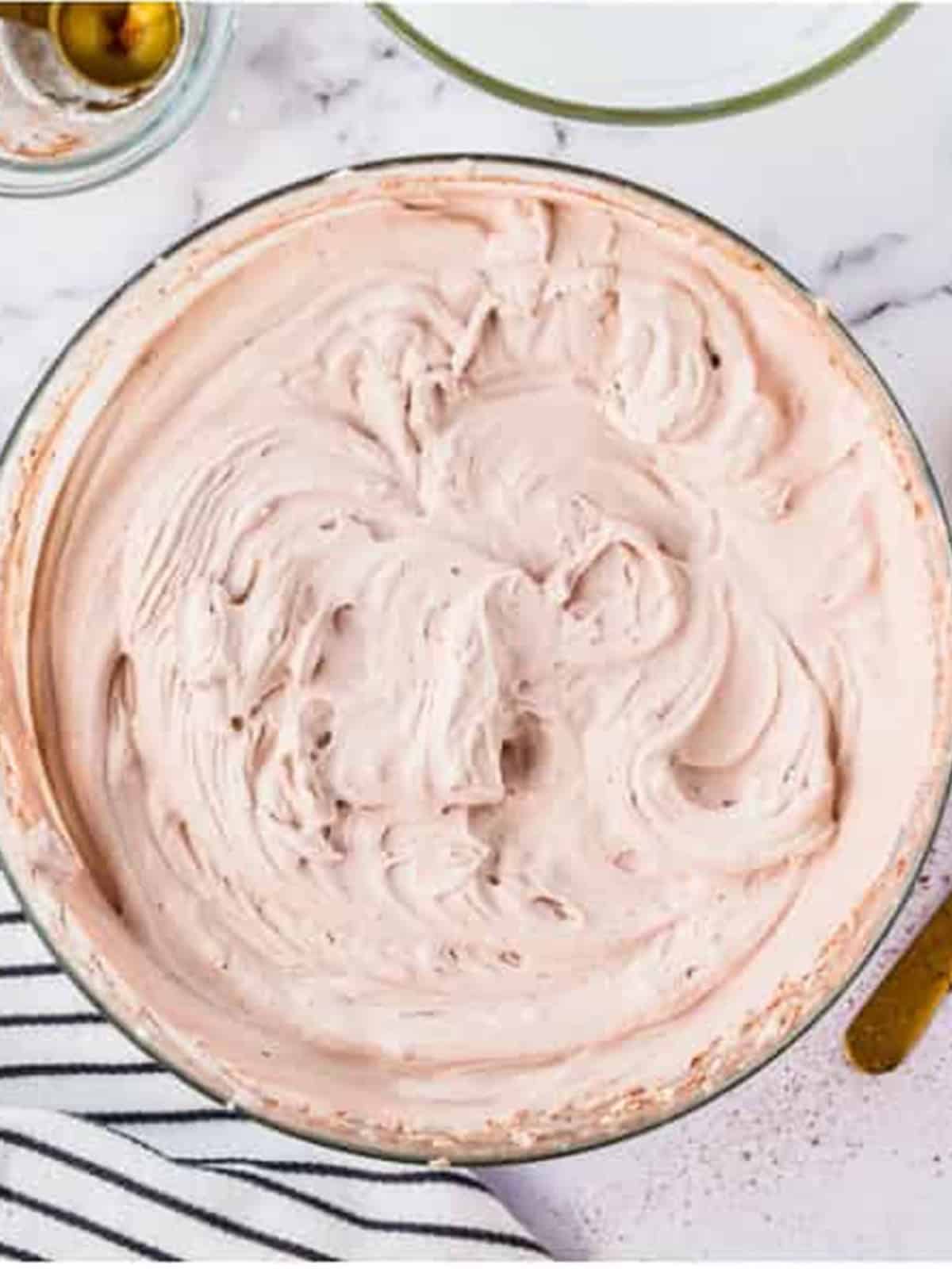 Chocolate Whipped Cream whipped to soft peaks in a bowl.