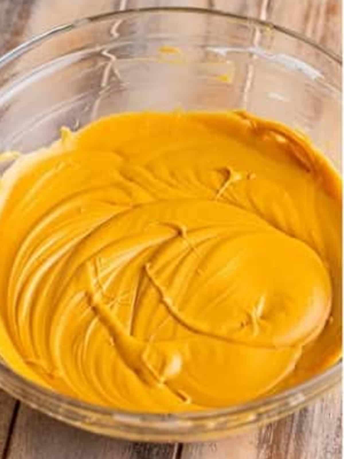 Whipping cream cheese and dulce de leche together into a smooth golden filling.