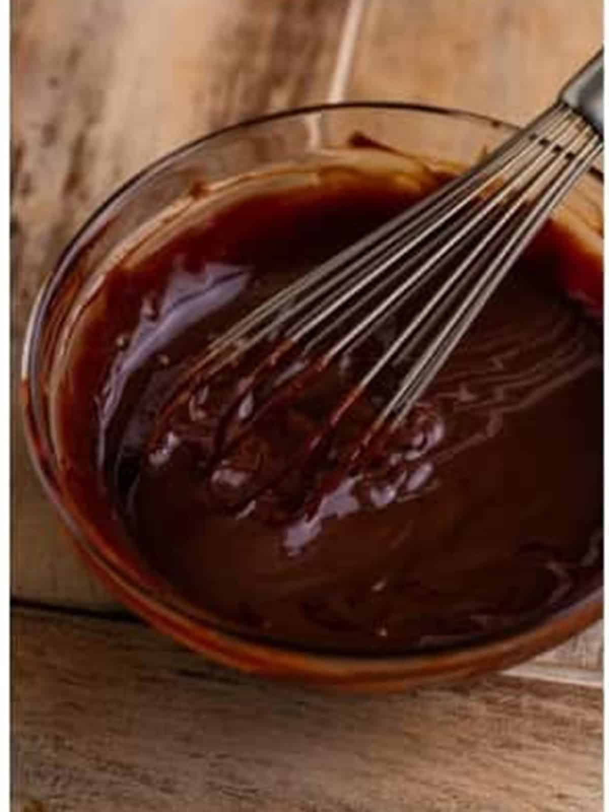 Whisking the chocolate ganache until smooth and glossy.