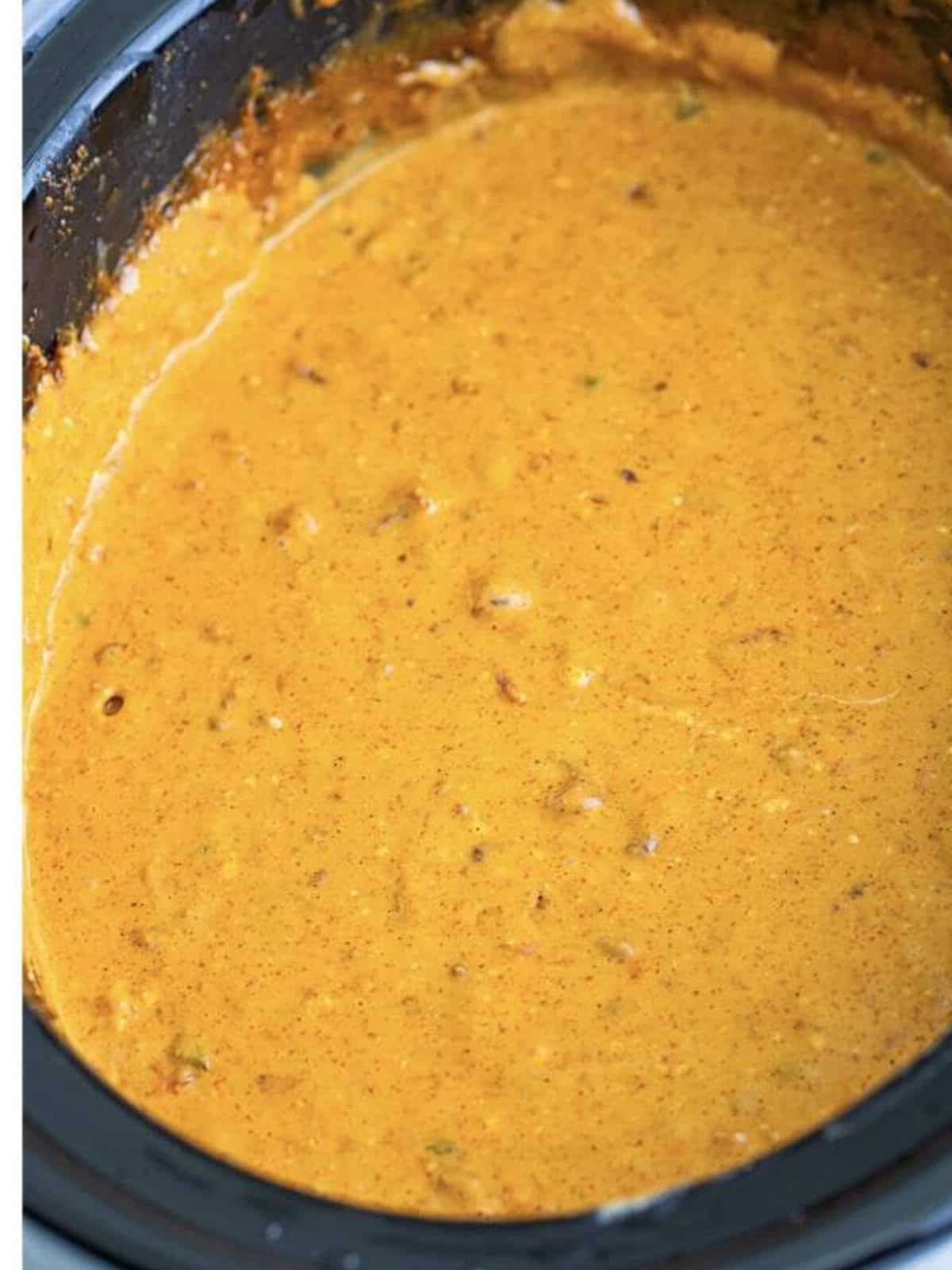 Smooth melted crock pot queso dip with chorizo in the slow cooker.