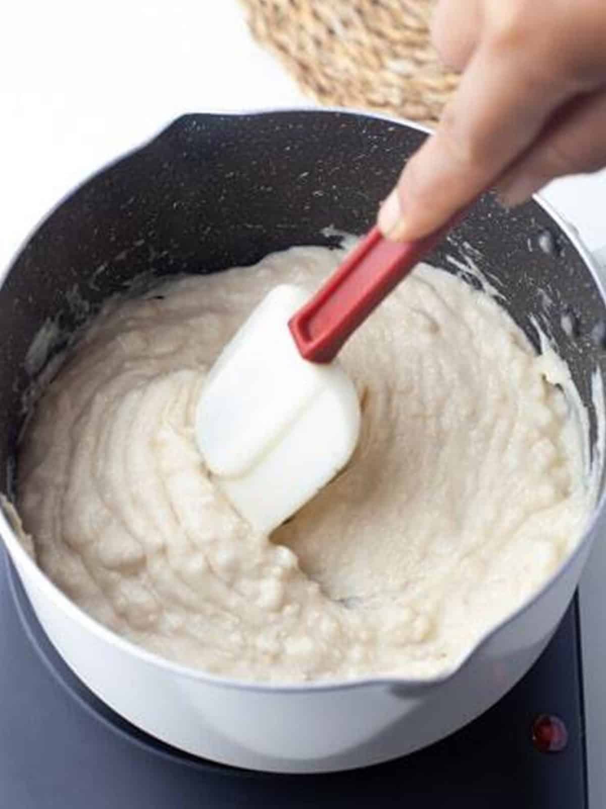 Flour stirred into the hot butter mixture to form a smooth churro paste.