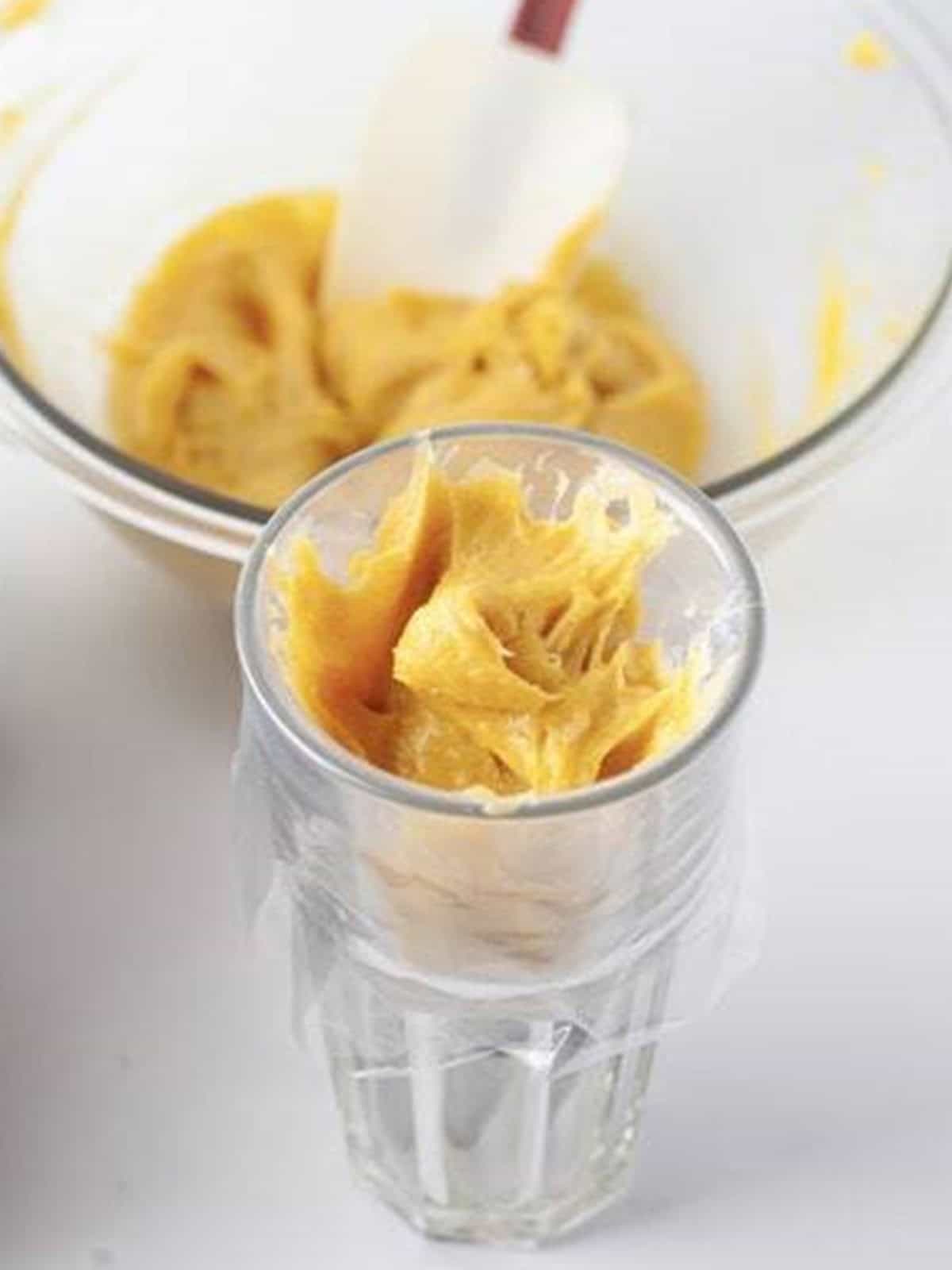 Churro dough transferred to a piping bag fitted with a star tip.