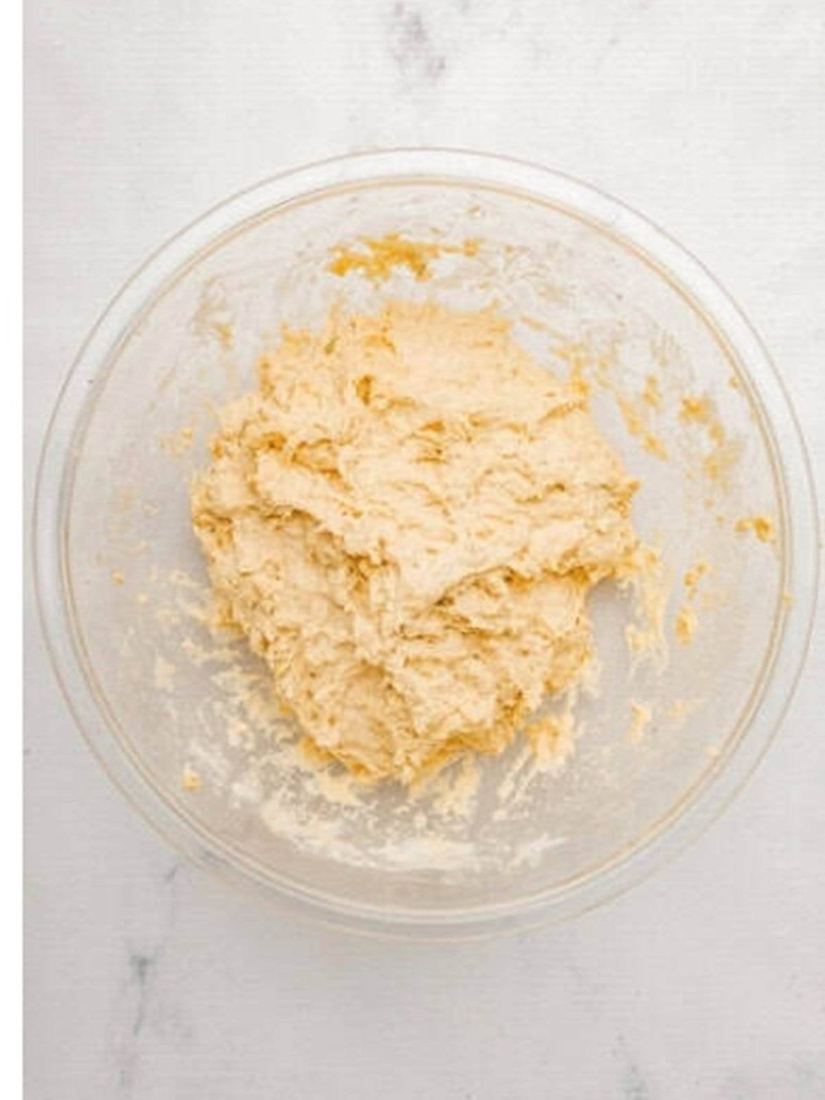 Wet ciabatta dough mixed in a glass bowl