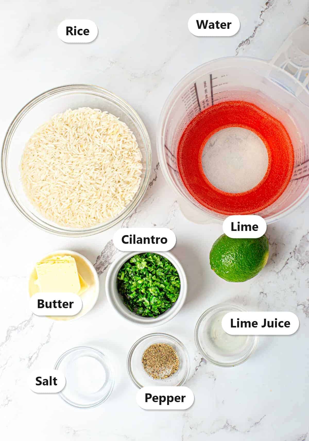 Labeled cilantro lime rice ingredients including rice, water, butter, lime, cilantro, salt, and pepper on a marble counter.