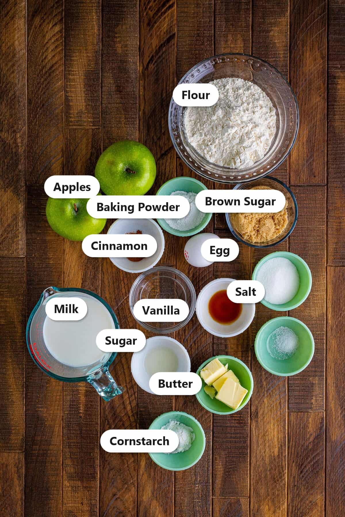 Labeled ingredients for Cinnamon Apple Pancakes including flour, Granny Smith apples, brown sugar, cinnamon, milk, egg, butter, and baking powder.