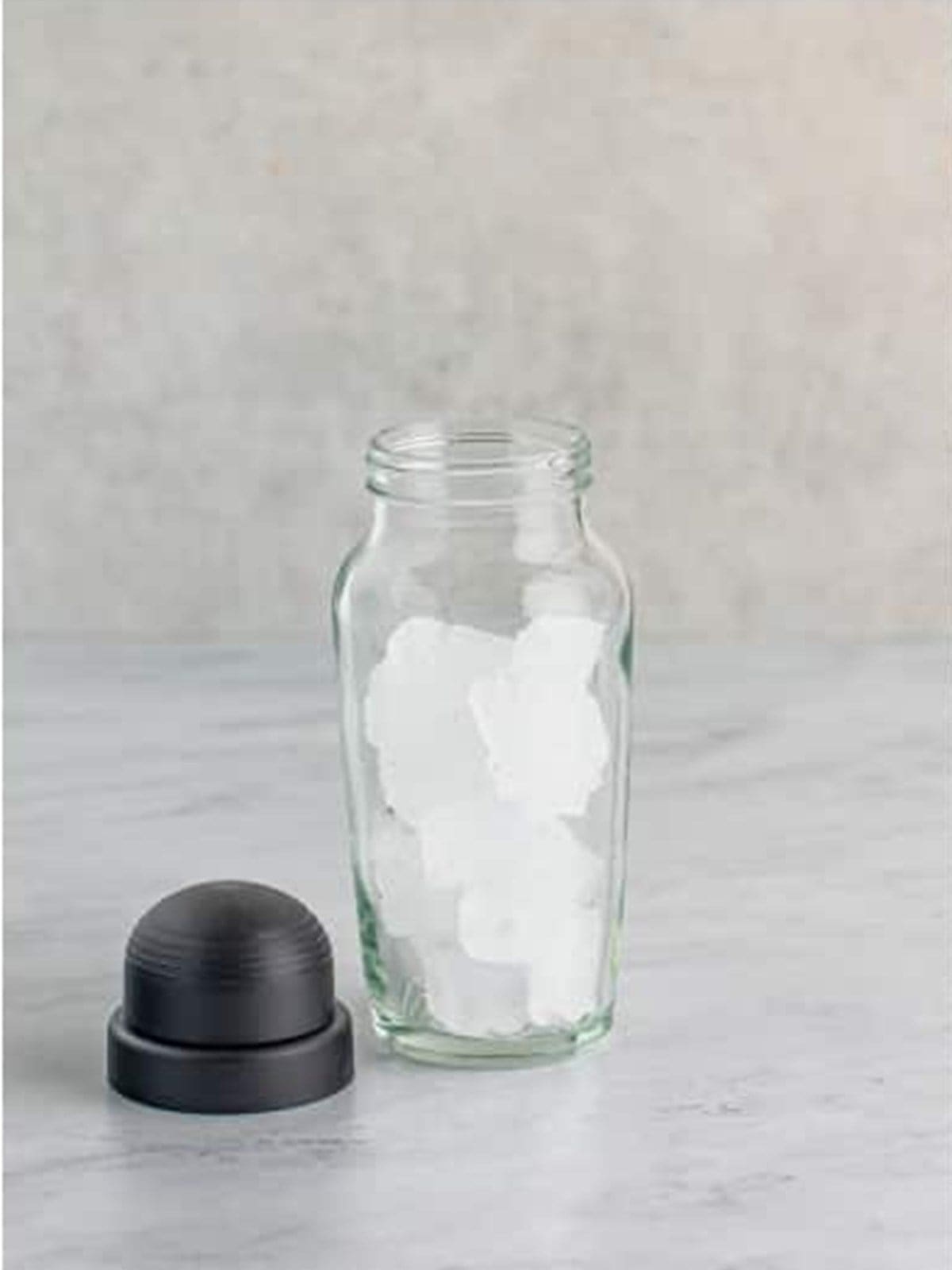 Cocktail shaker filled halfway with ice for cinnamon roll cocktail.
