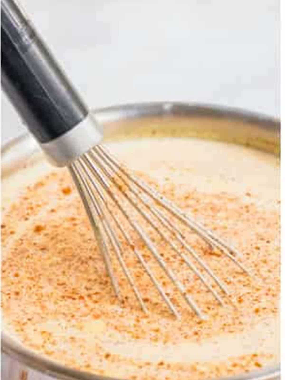 Eggs, yolks, and sugar beaten until frothy with a hand mixer for eggnog.