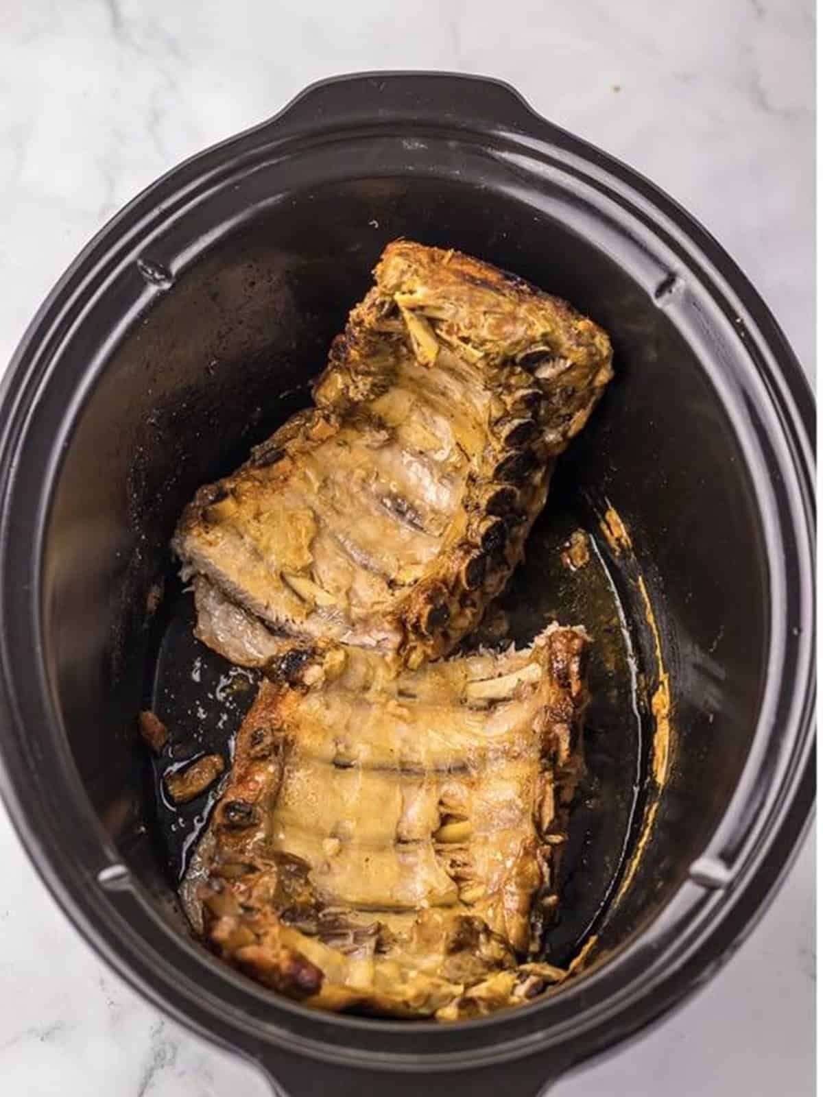 Tender slow cooked ribs in the slow cooker.