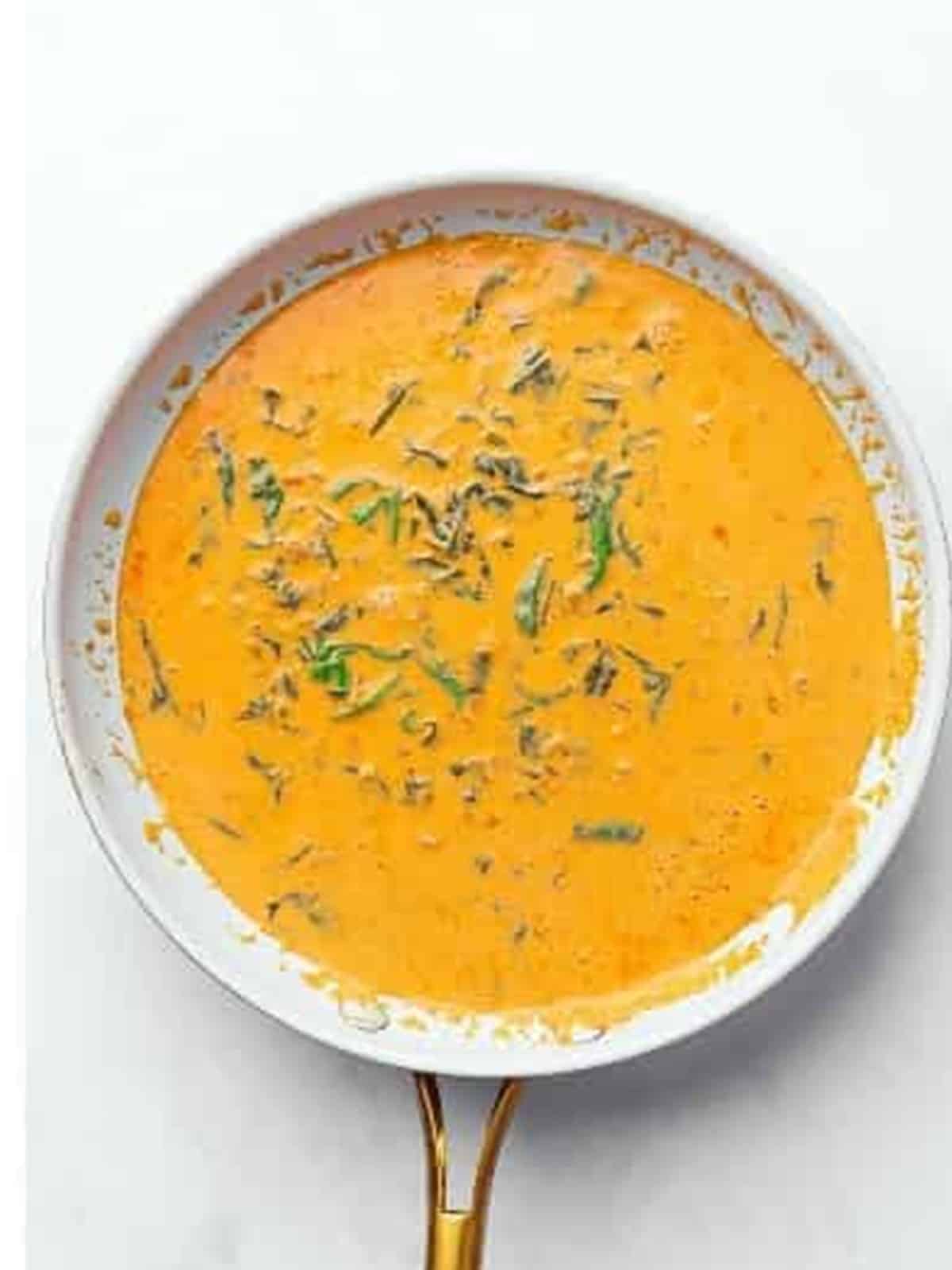 Finished coconut curry sauce with spinach and herbs simmering in the pan.