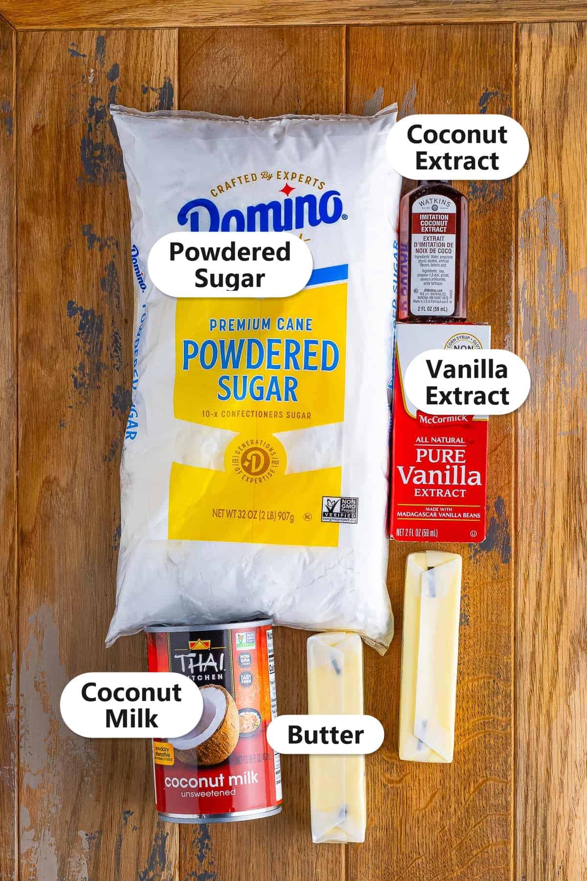 Labeled coconut frosting ingredients including powdered sugar, salted butter, coconut milk, coconut extract, and vanilla extract.