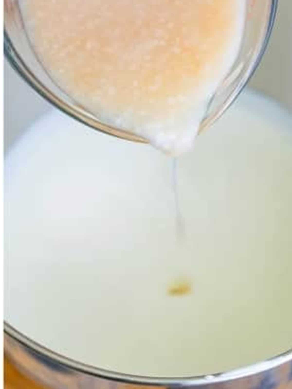 Streaming cream of coconut into the whipped cream to make the Coconut Ice Cream base.