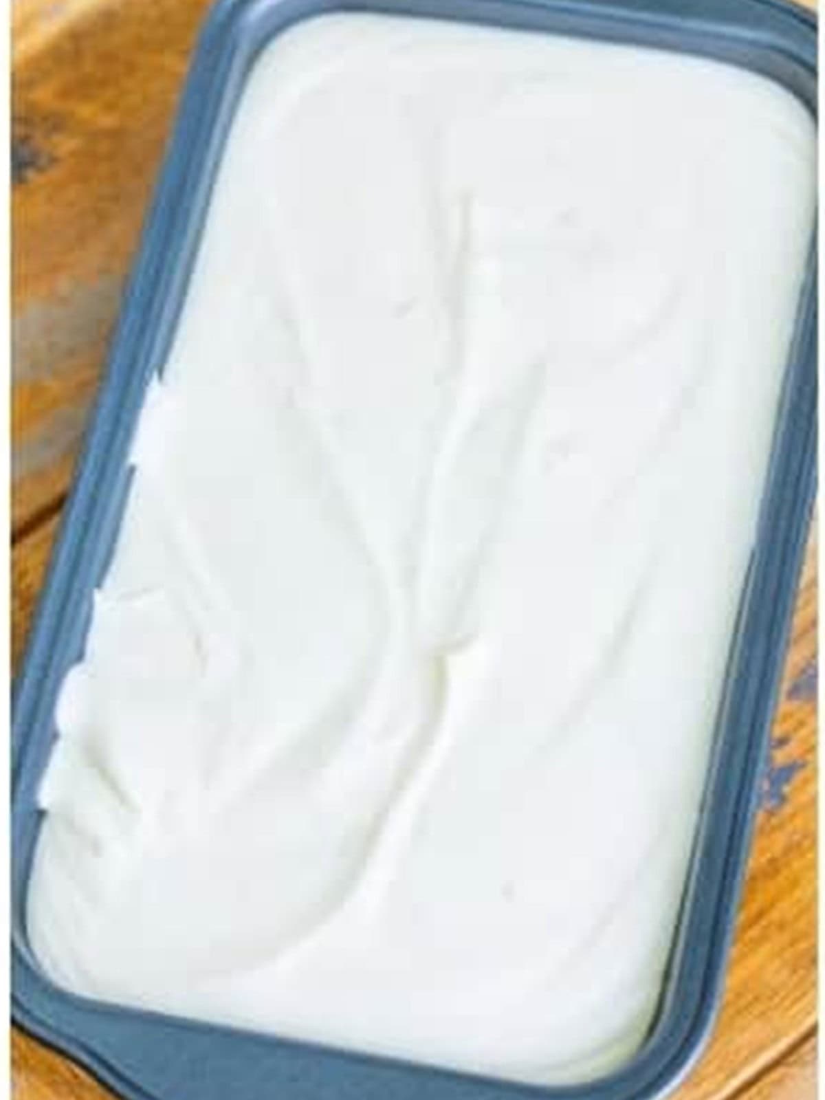 Smooth Coconut Ice Cream base spread in a loaf dish ready to freeze.