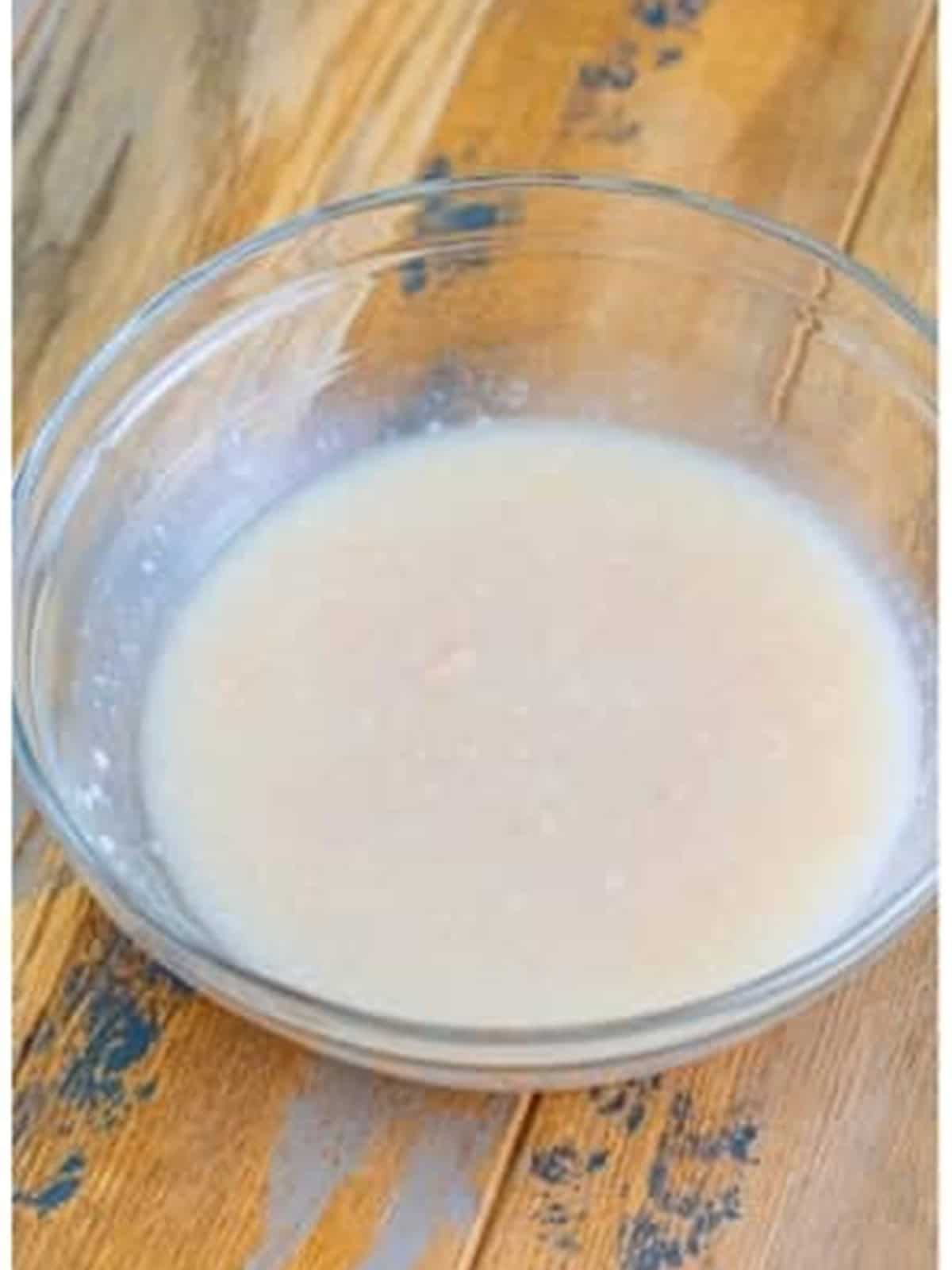 Cream of coconut whipped smooth in a glass bowl for Coconut Ice Cream.