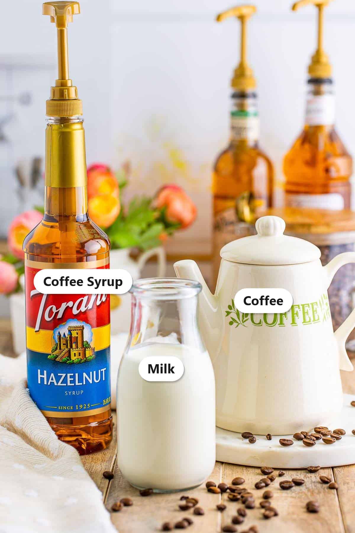 Coffee syrup, milk, and a coffee canister set out to make flavored coffee at home.
