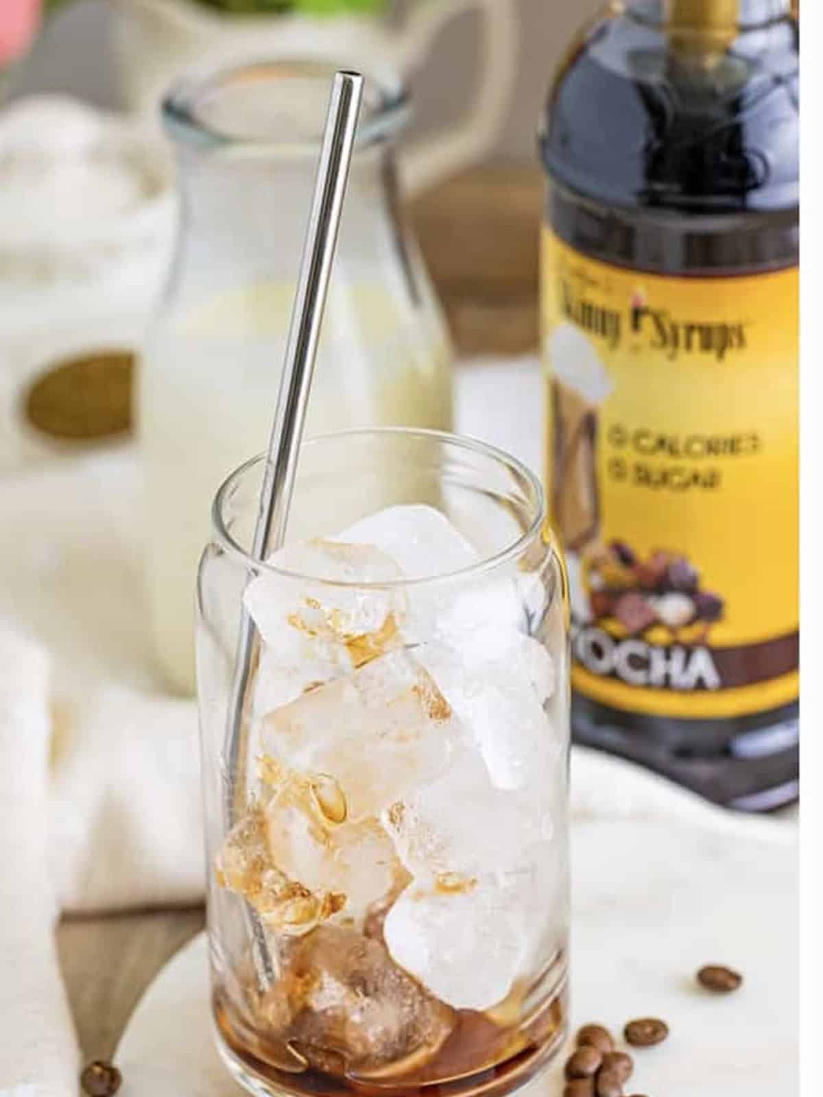 A tall glass filled with ice for an iced coffee.