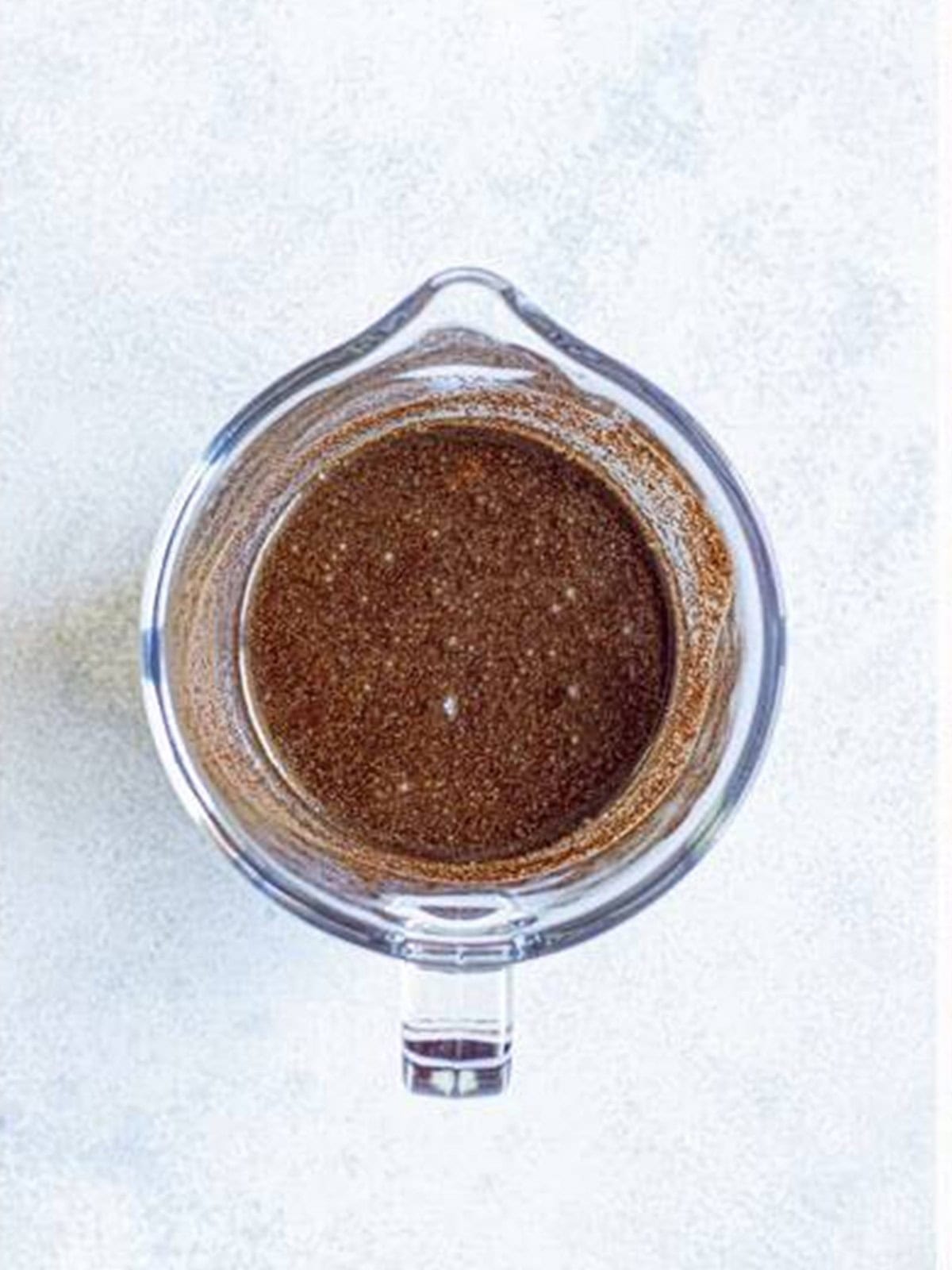 Water added to the coffee grounds and stirred together.
