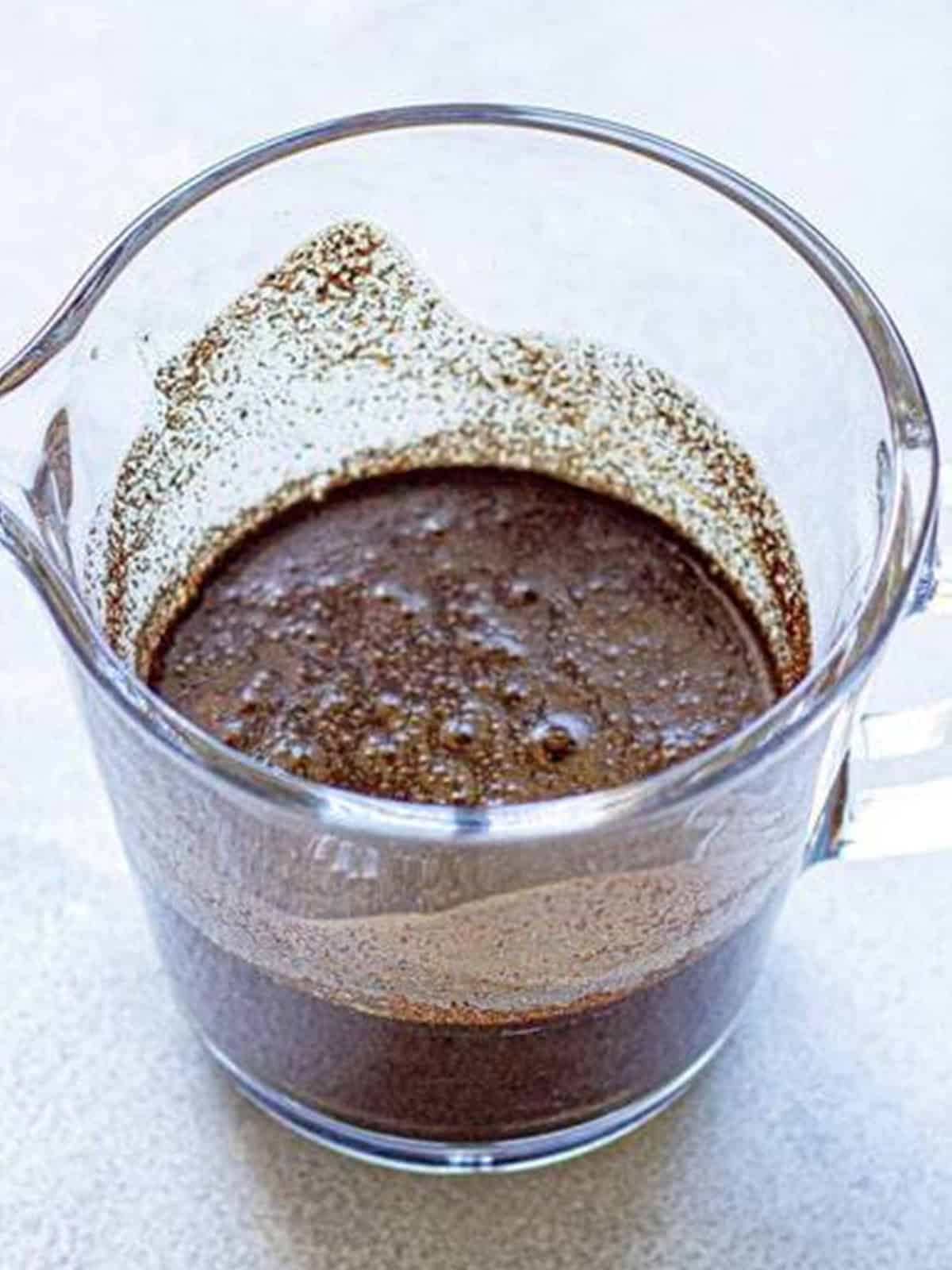 Coffee grounds steeping in water for cold brew.