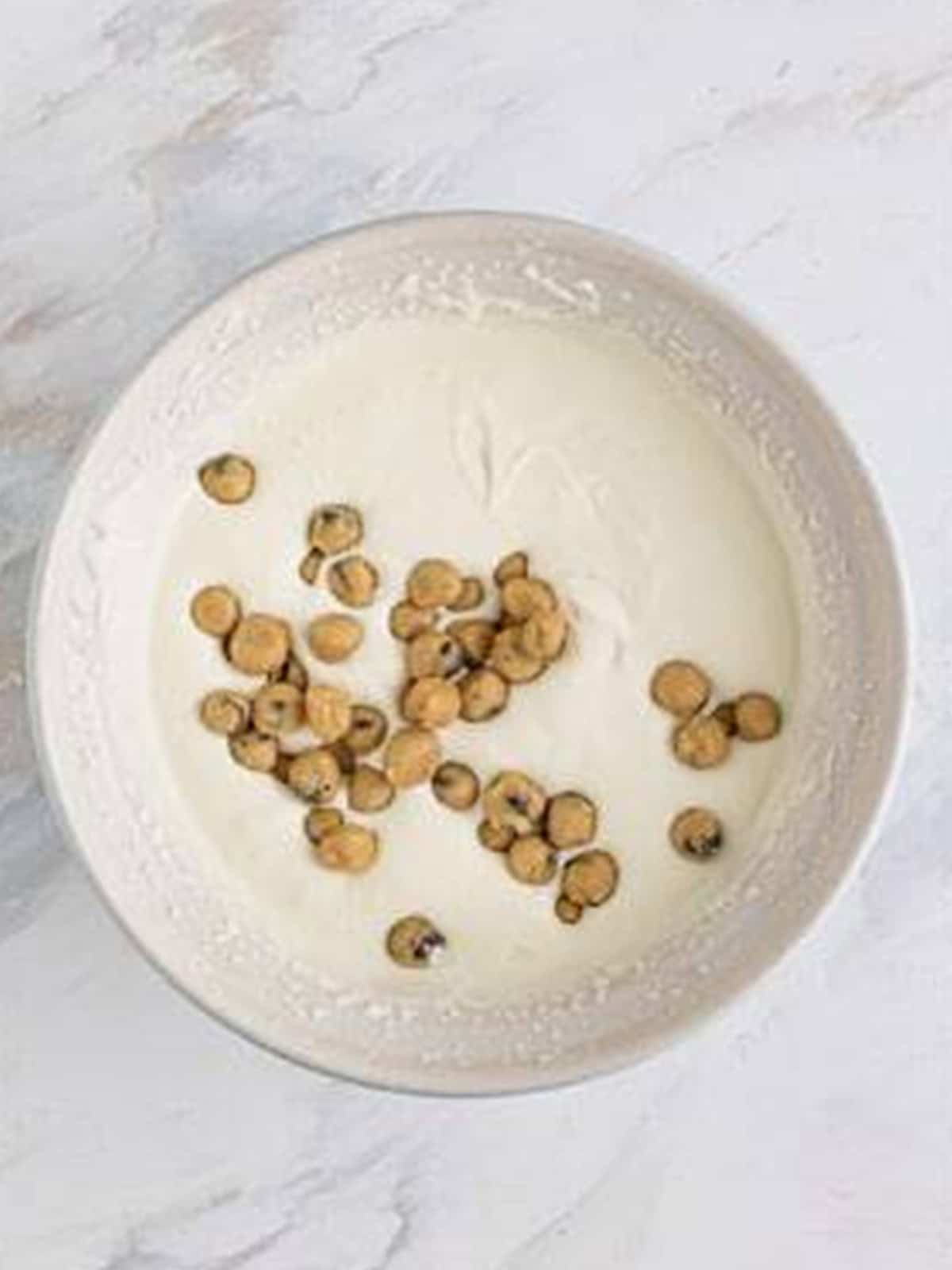 Cookie dough balls folded into the whipped no churn ice cream base.