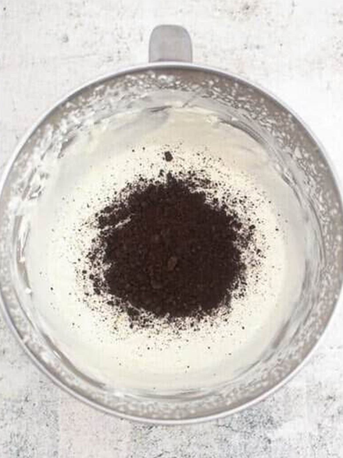 Folding cookie crumbs into the whipped cream mixture.